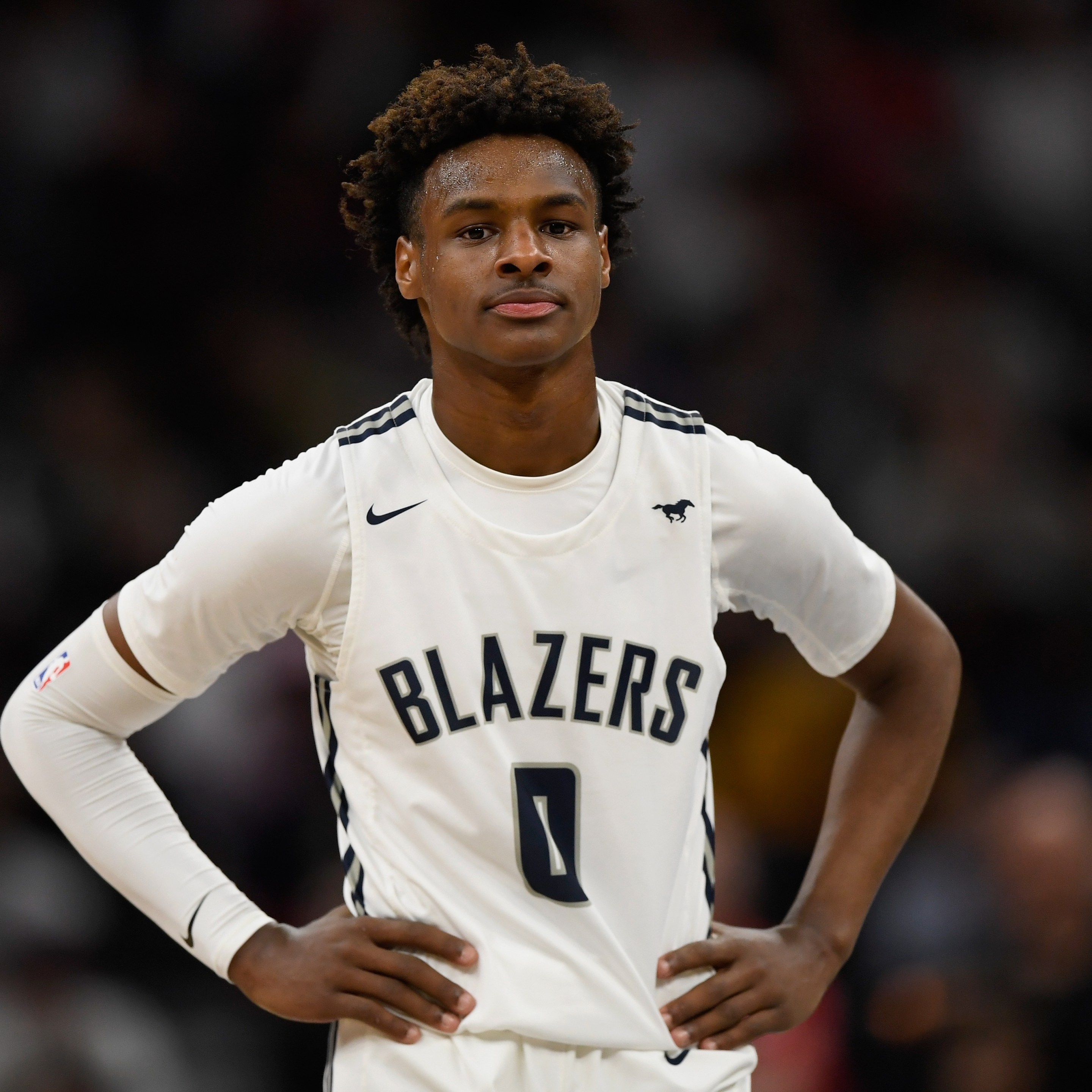 Bronny James looks on during a basketball game.