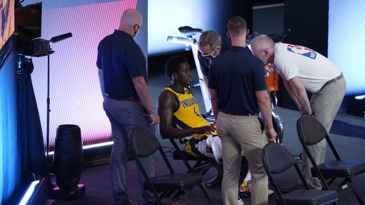 Victor Oladipo of the Indiana Pacers, surrounded by team staffers