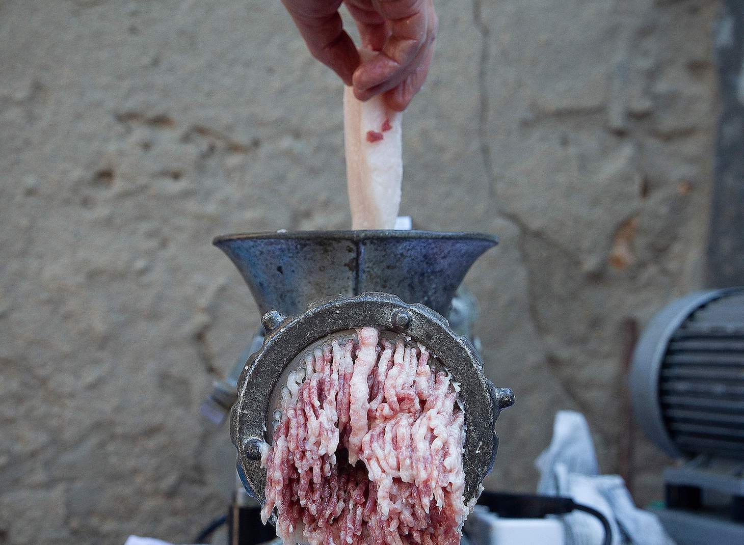 A member of the Ripoll Taberner family minces meat during the annual tradition of the pig slaughter (matanza de cerdo) in Llucmajor on the Spanish Balearic Island of Mallorca on November 23, 2020. - For the traditional slaughter, a pig is fattened up for a year and then killed on a cold day to ensure the best conservation of the "sobrasada" sausages. (Photo by JAIME REINA / AFP) (Photo by JAIME REINA/AFP via Getty Images)