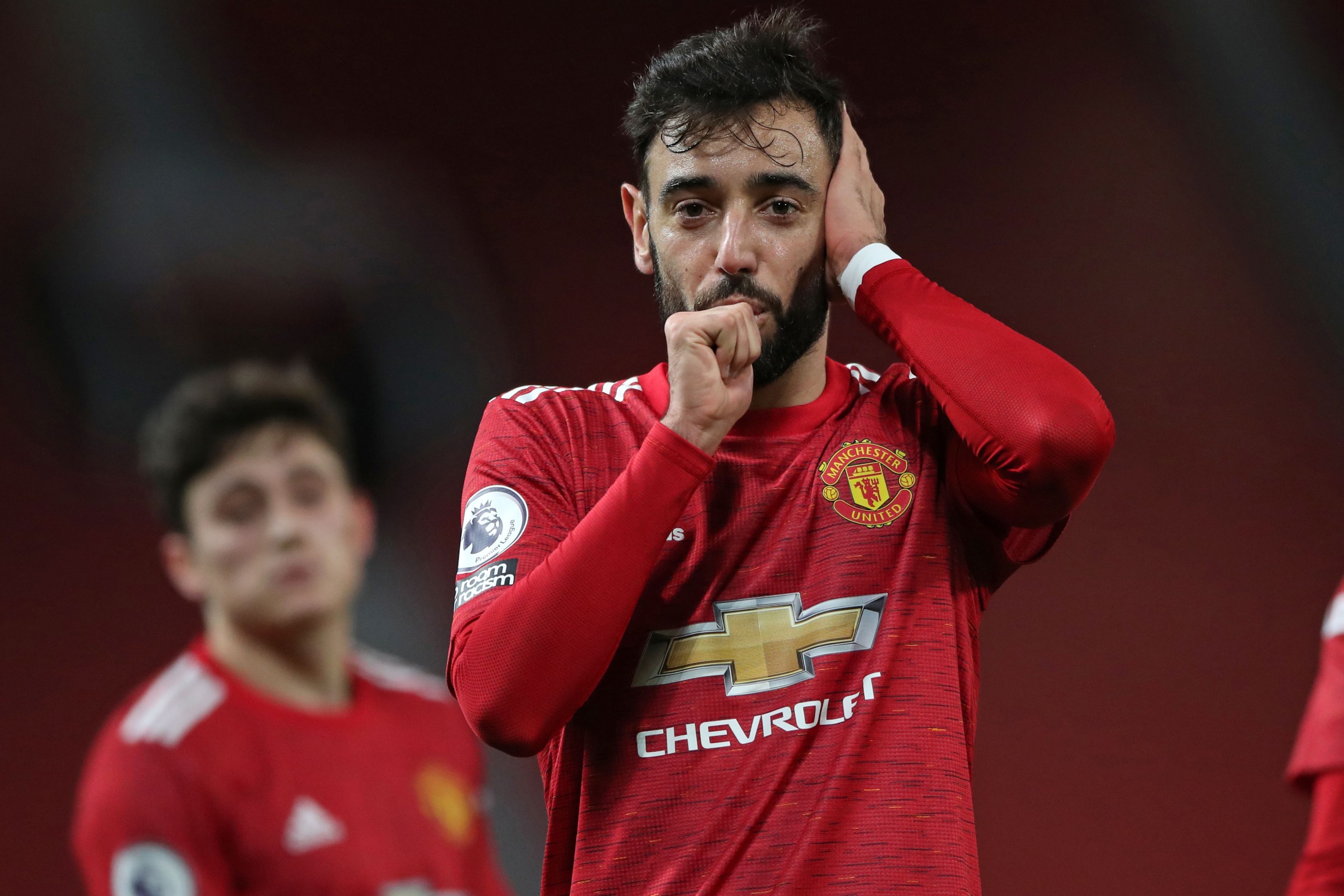 Manchester United's Portuguese midfielder Bruno Fernandes celebrates after scoring their third goal during the English Premier League football match between Manchester United and Leeds United at Old Trafford in Manchester, north west England, on December 20, 2020.