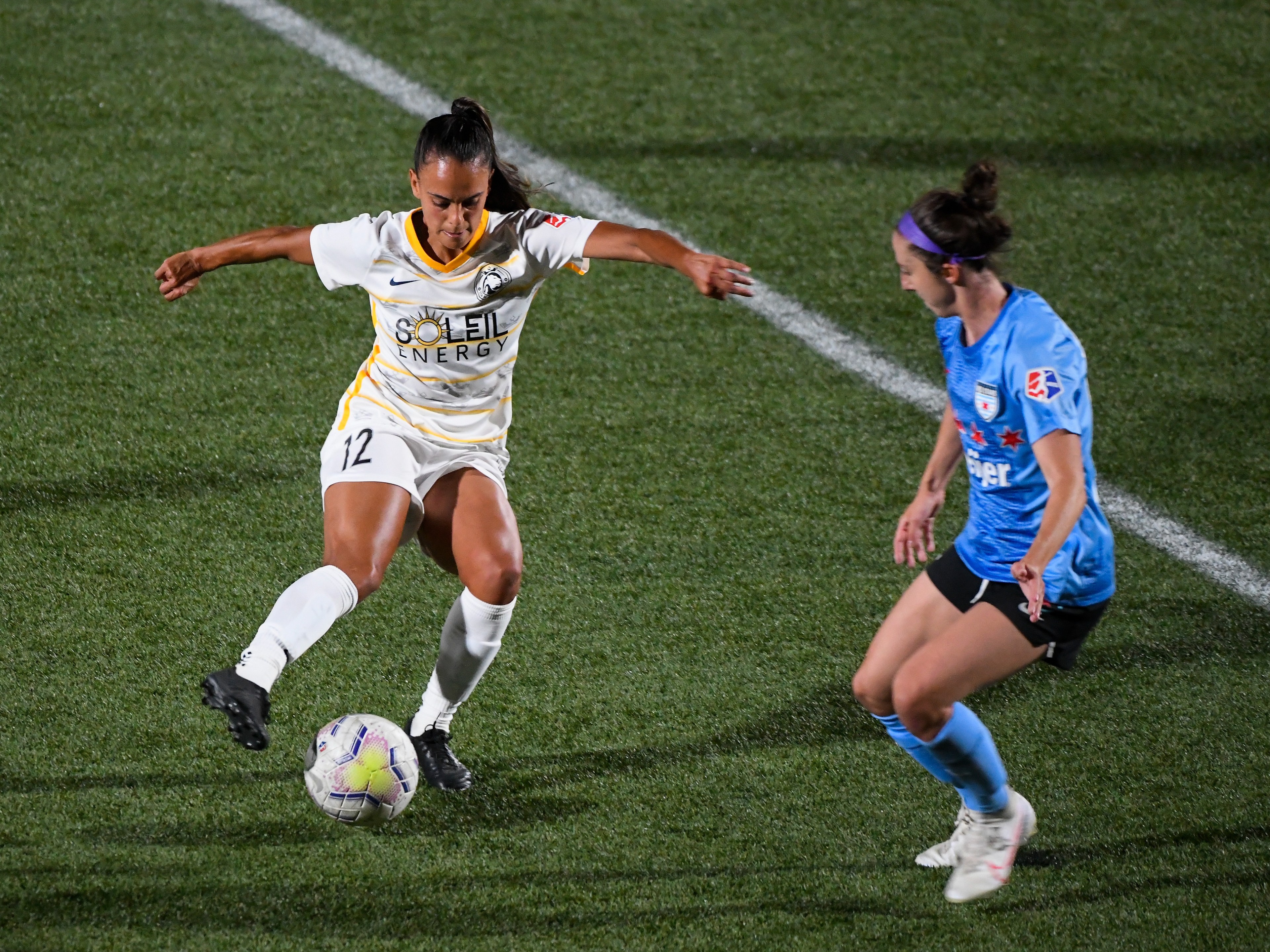 two nwsl players fight for a ball