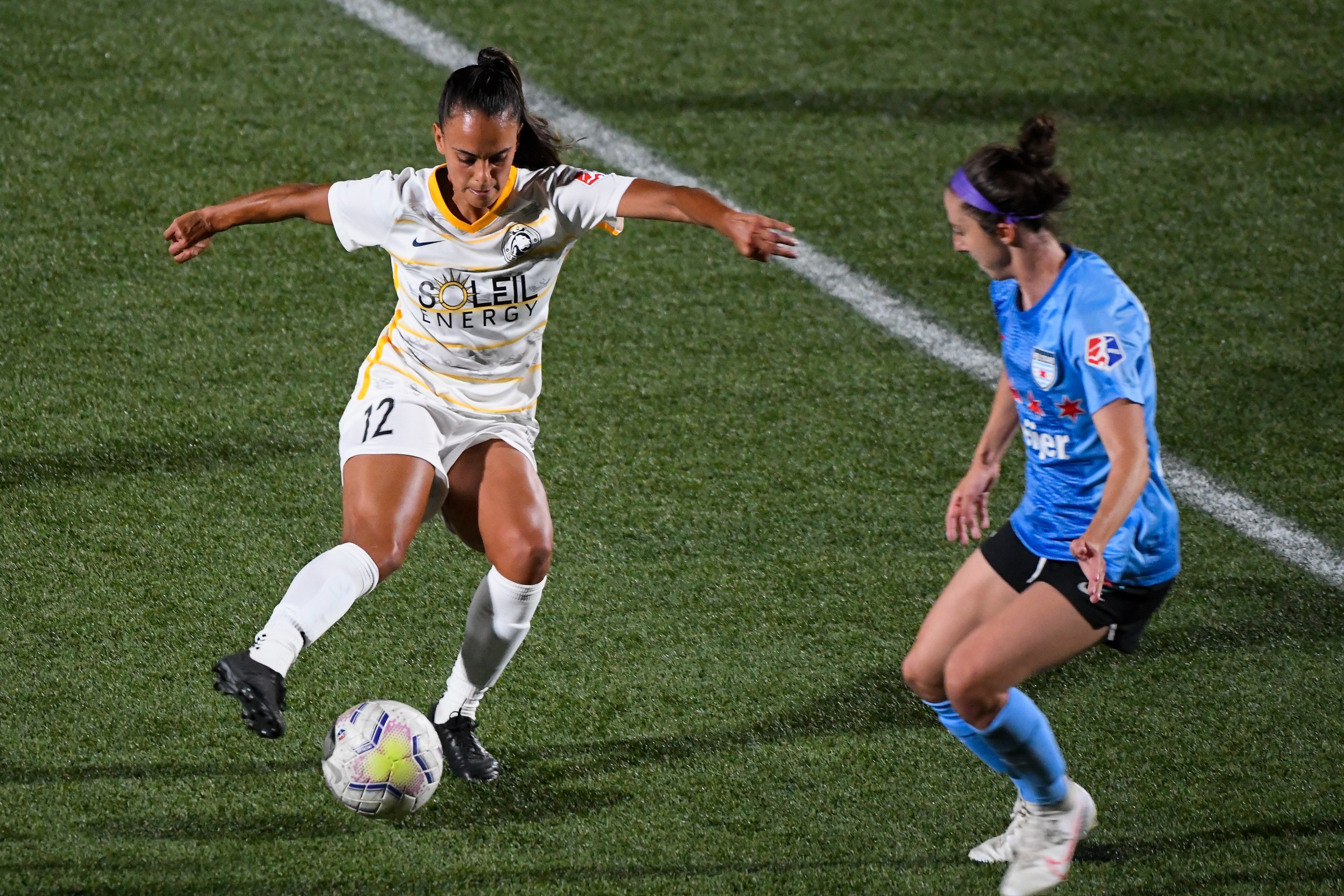 two nwsl players fight for a ball