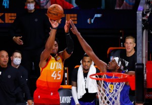Donovan Mitchell of the Utah Jazz shoots over the outstretched arm of Jerami Grant of the Denver Nuggets