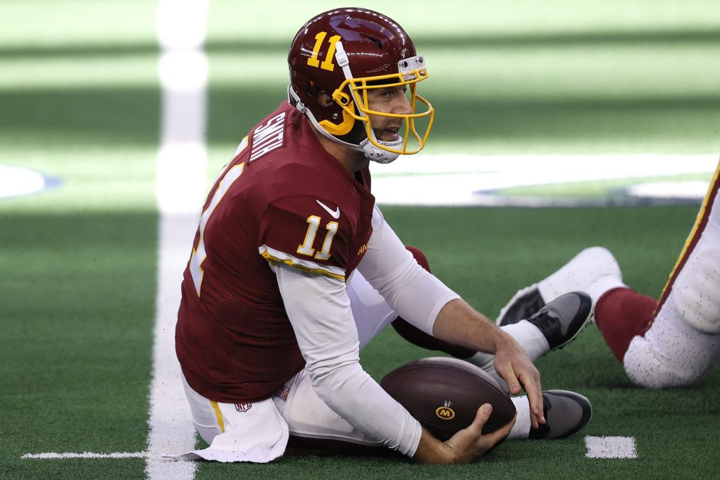 Washington Football Team quarterback Alex Smith lies crumpled on the turf after being tackled. He's fine! Both legs are intact.