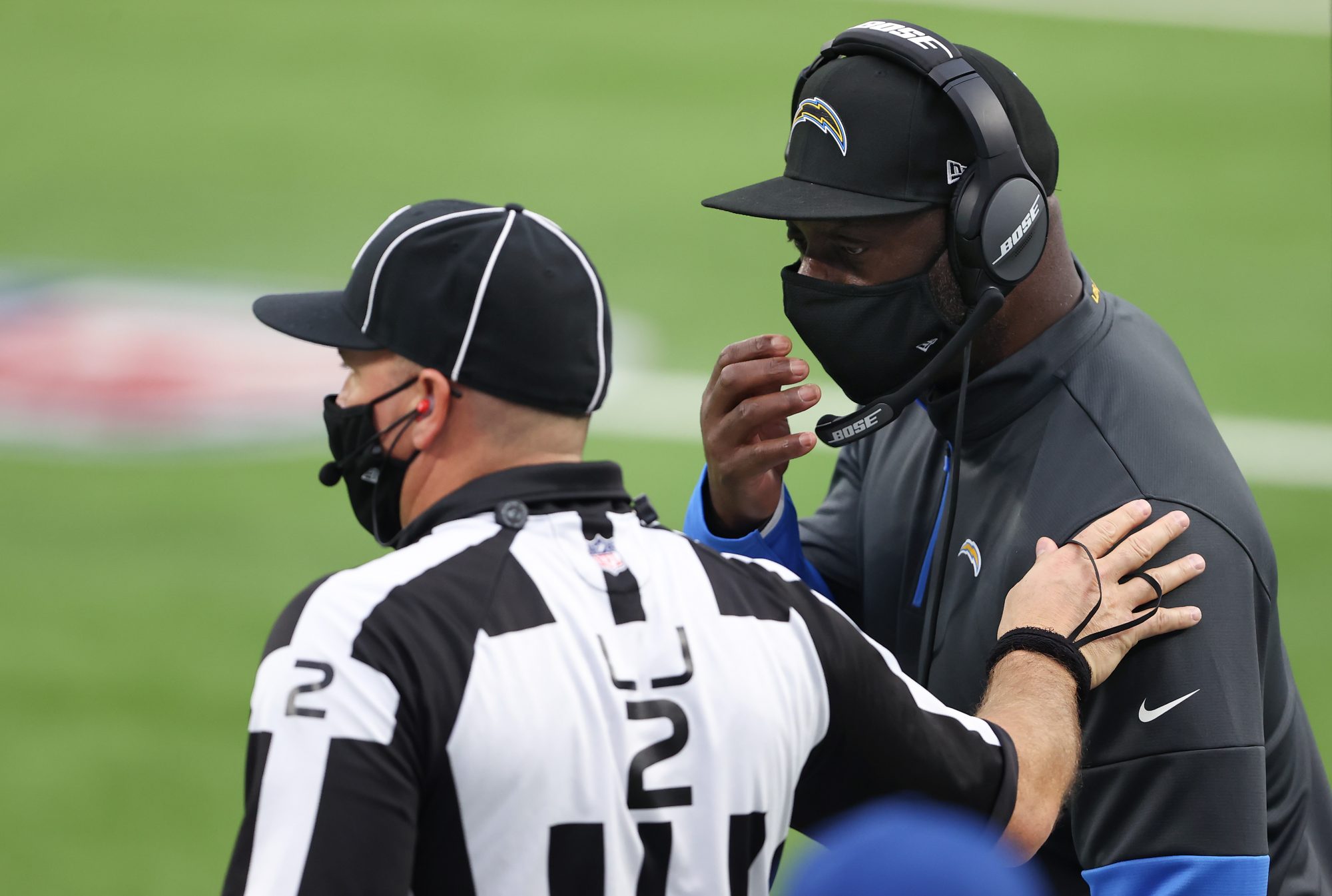 Chargers head coach Anthony Lynn talks with an official.
