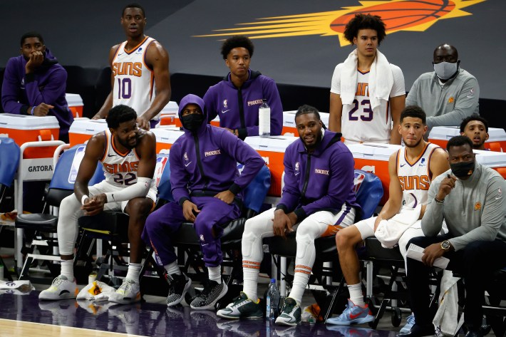 Some Phoenix Suns players sit on the bench