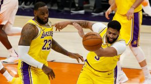 LeBron James and Anthony Davis of the Los Angeles Lakers pursue a loose ball