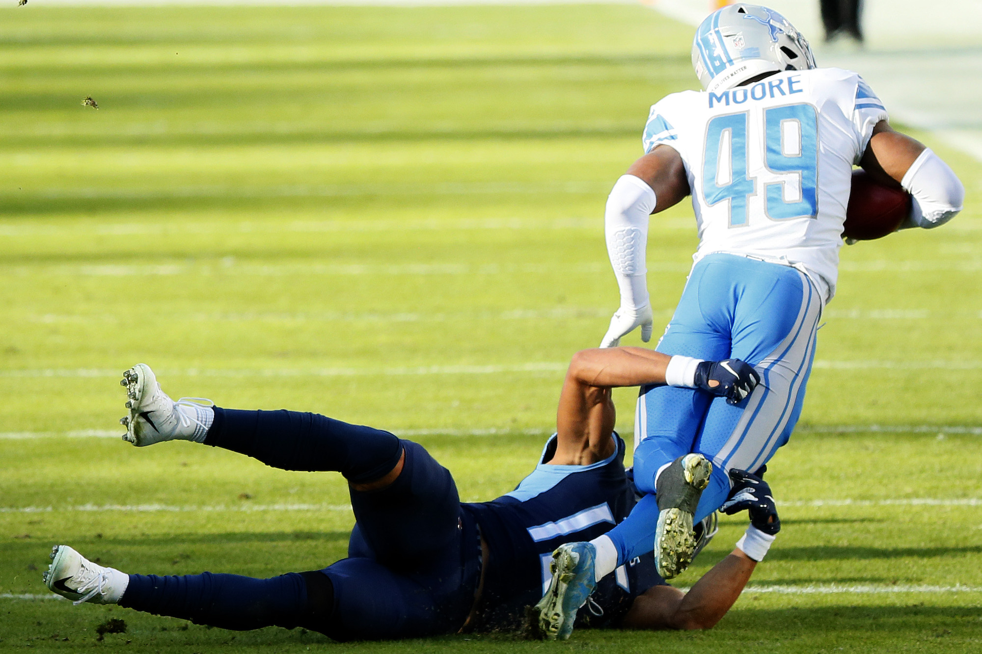 NASHVILLE, TENNESSEE - DECEMBER 20: C.J. Moore #49 of the Detroit Lions is tackled short of a first down by Nick Westbrook #15 of the Tennessee Titans for a turnover on downs on a fake punt during the fourth quarter of the game at Nissan Stadium on December 20, 2020 in Nashville, Tennessee. (Photo by Frederick Breedon/Getty Images)