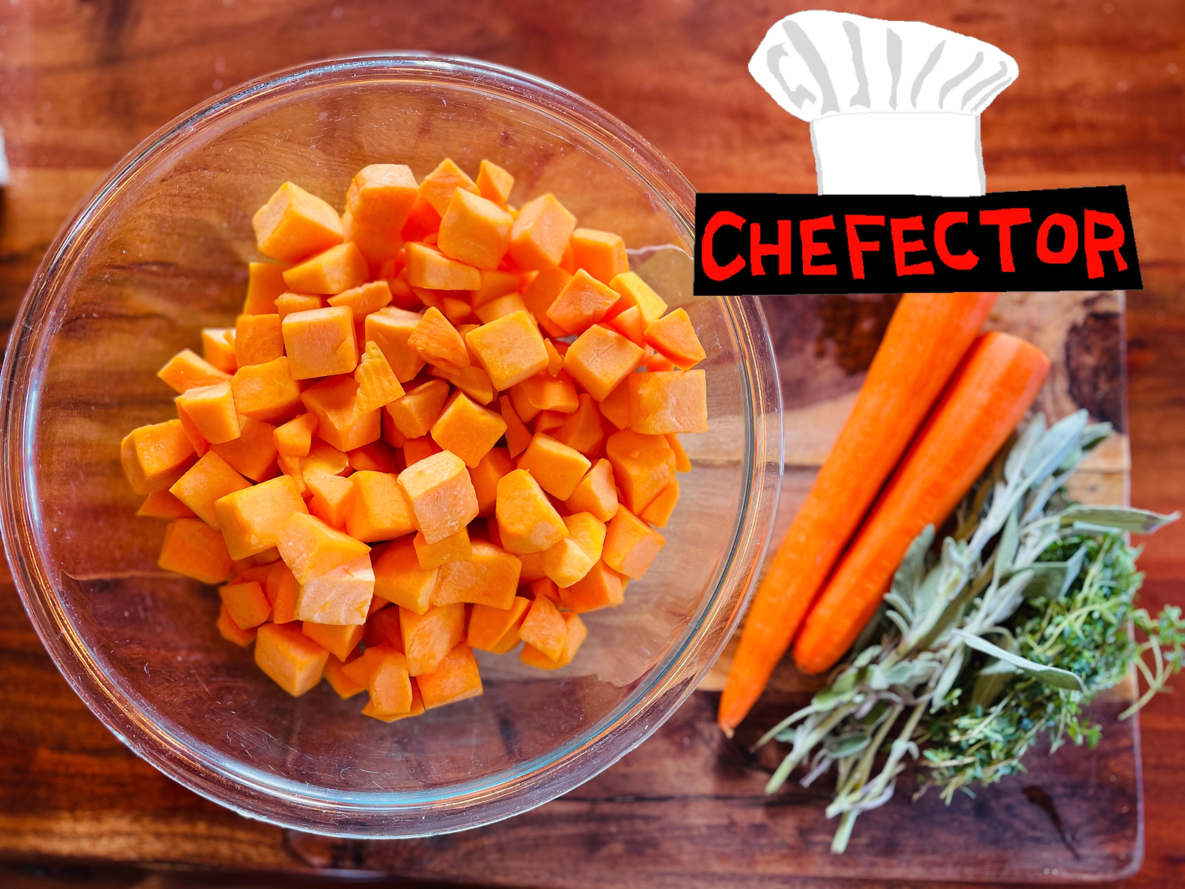 Squash hunks, carrots, herbs, on a wooden surface