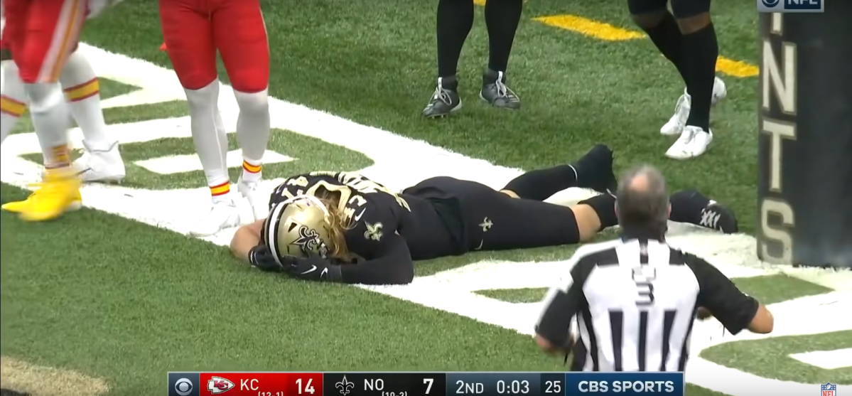 Saints player lays face down in the end zone after failing to recovery a fumble