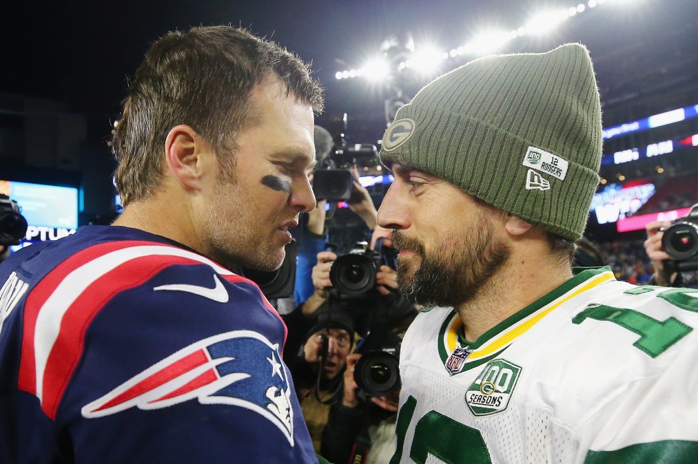 Tom Brady #12 of the New England Patriots talks with Aaron Rodgers #12 of the Green Bay Packers