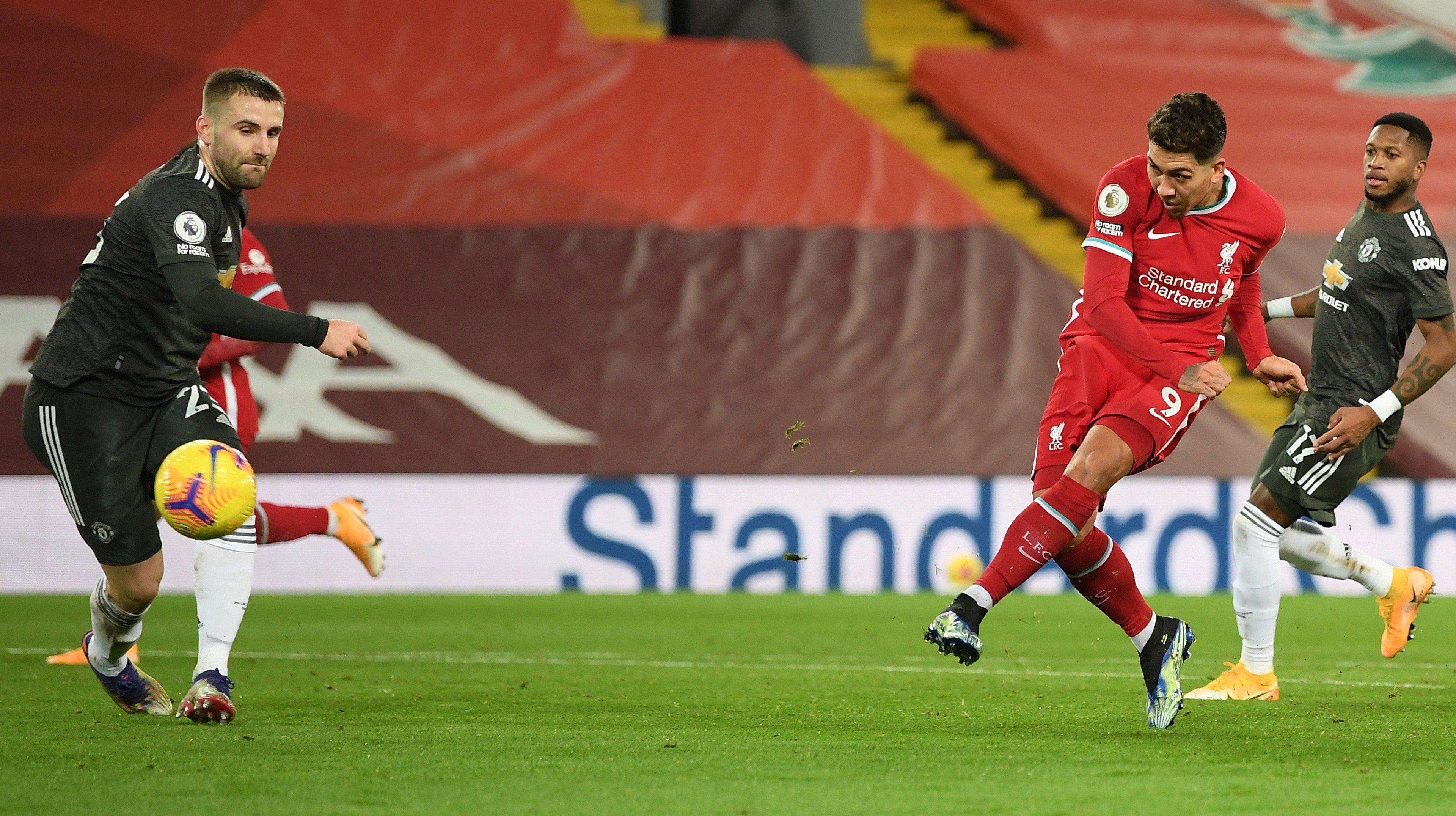 Liverpool's Brazilian midfielder Roberto Firmino shoots but fails to score during the English Premier League football match between Liverpool and Manchester United at Anfield in Liverpool, north west England on January 17, 2021.