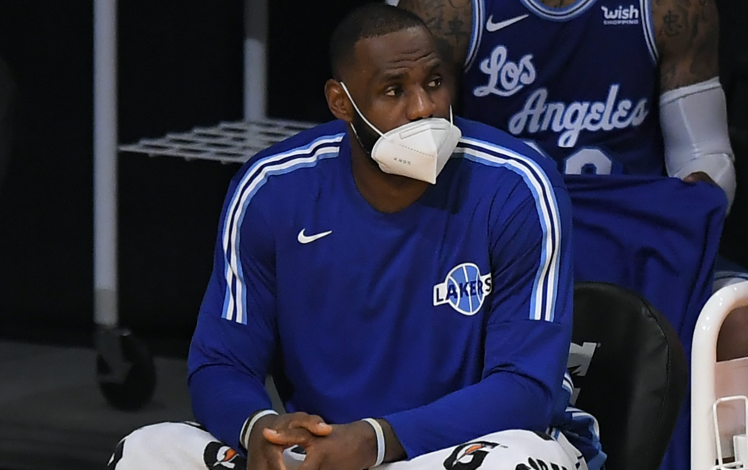 LOS ANGELES, CA - DECEMBER 27: LeBron James #23 of the Los Angeles Lakers wears a face mask on the bench in a game against the Minnesota Timberwolves at Staples Center on December 27, 2020 in Los Angeles, California. NOTE TO USER: User expressly acknowledges and agrees that, by downloading and/or using this photograph, user is consenting to the terms and conditions of the Getty aImages License Agreement. (Photo by John McCoy/Getty Images)