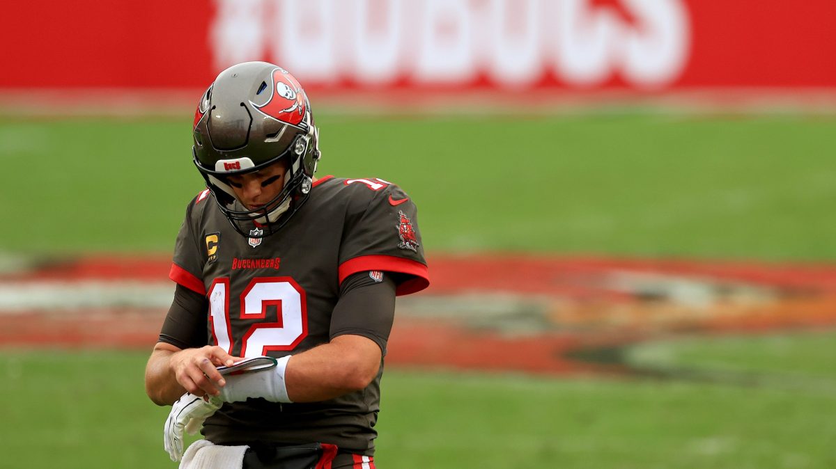 Quarterback Tom Brady looks down at his wristband during a Tampa Bay Buccaneers game.