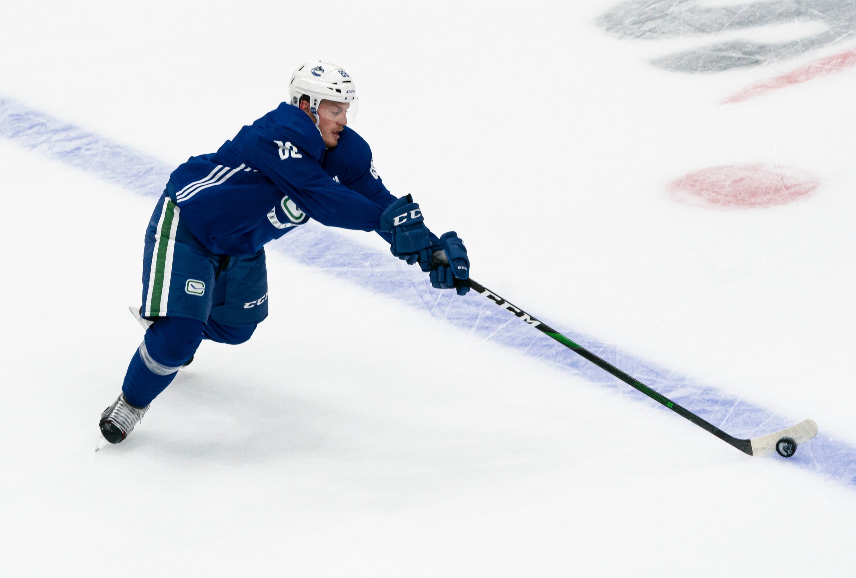 Nate Schmidt #88 of the Vancouver Canucks reaches for the puck