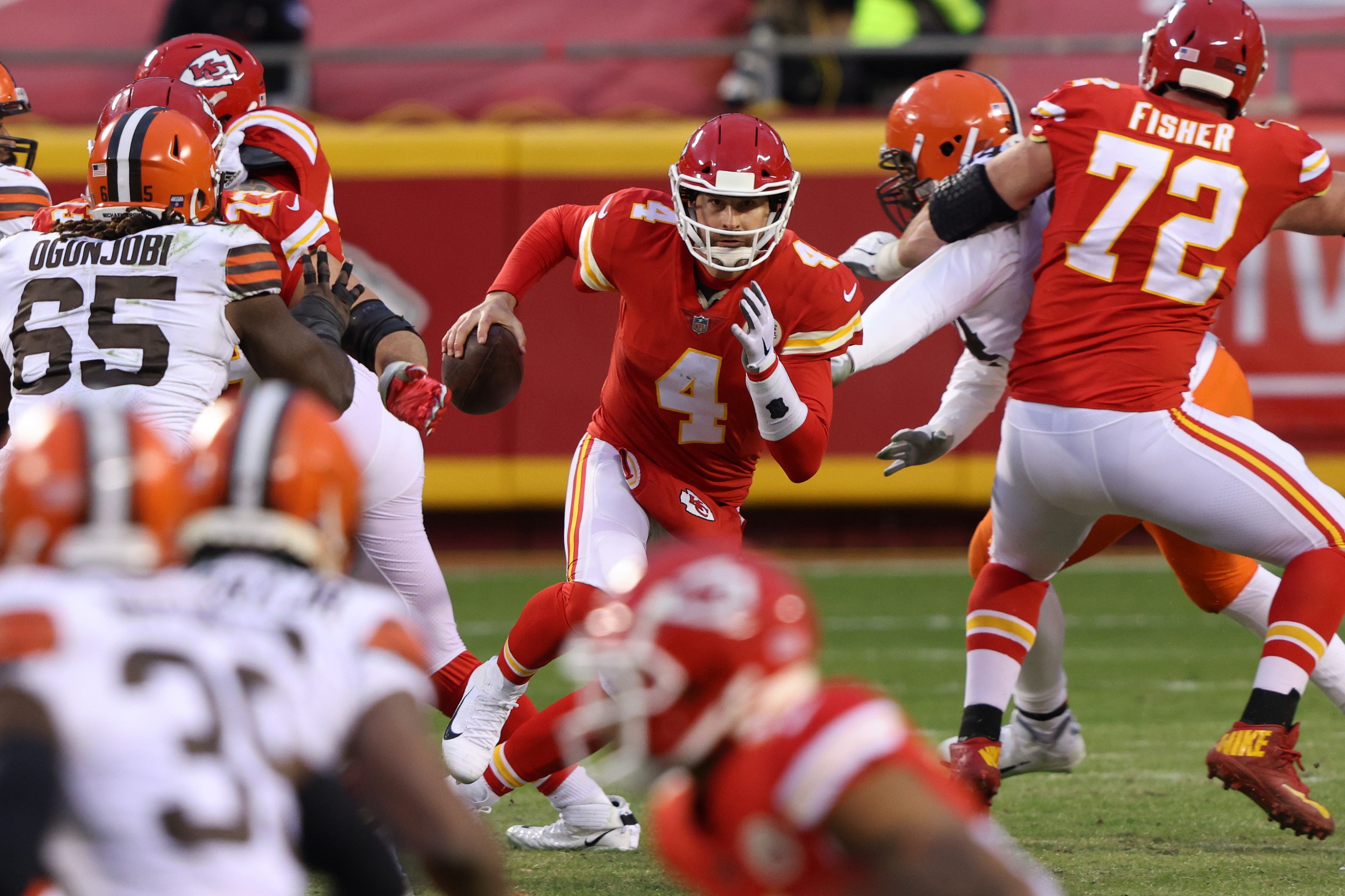Quarterback Chad Henne #4 of the Kansas City Chiefs scrambles against the defense of the Cleveland Browns late in the fourth quarter of the AFC Divisional Playoff game at Arrowhead Stadium on January 17, 2021 in Kansas City, Missouri.