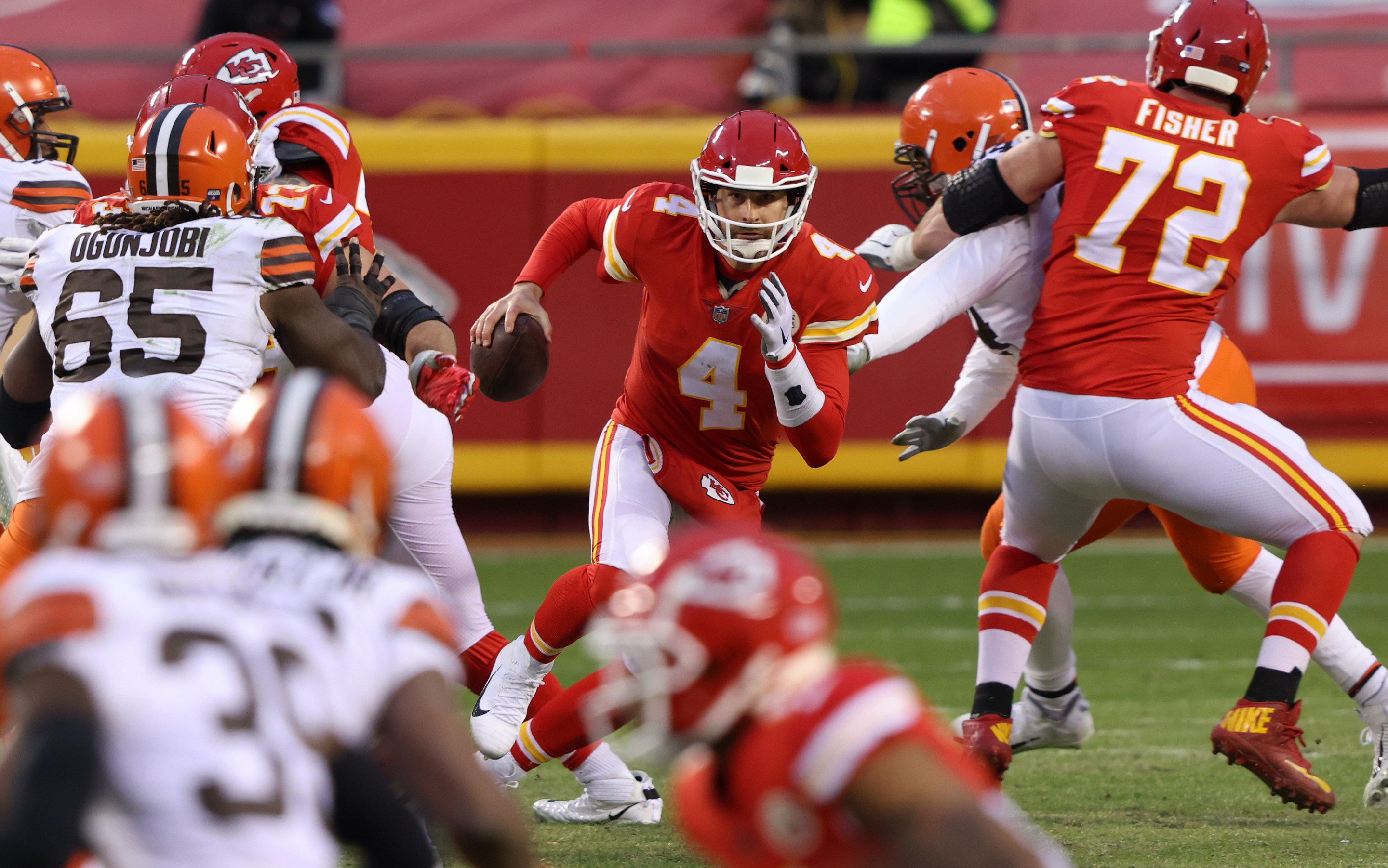 Quarterback Chad Henne #4 of the Kansas City Chiefs scrambles against the defense of the Cleveland Browns late in the fourth quarter of the AFC Divisional Playoff game at Arrowhead Stadium on January 17, 2021 in Kansas City, Missouri.
