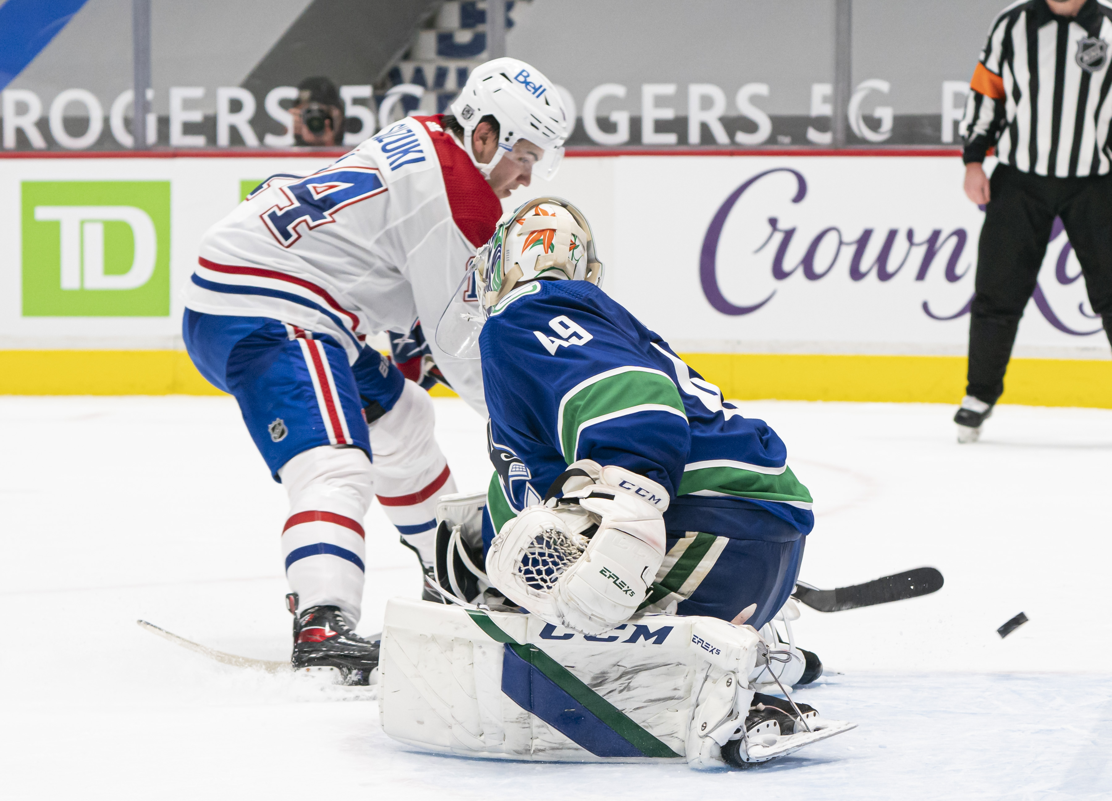 Nick Suzuki #14 of the Montreal Canadiens puts the puck past goalie Braden Holtby