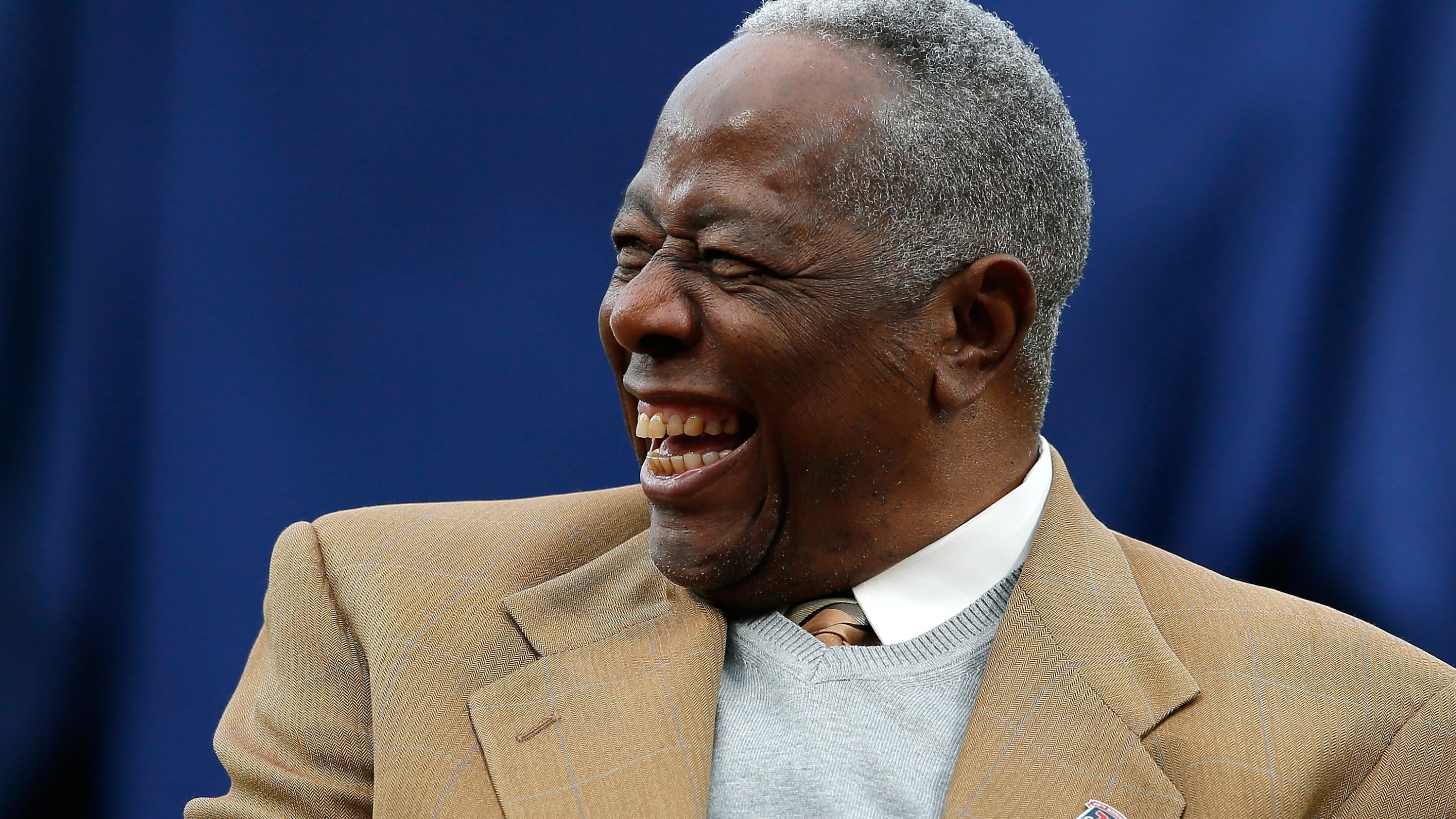 Hank Aaron, seen here laughing at a Mets/Braves game.