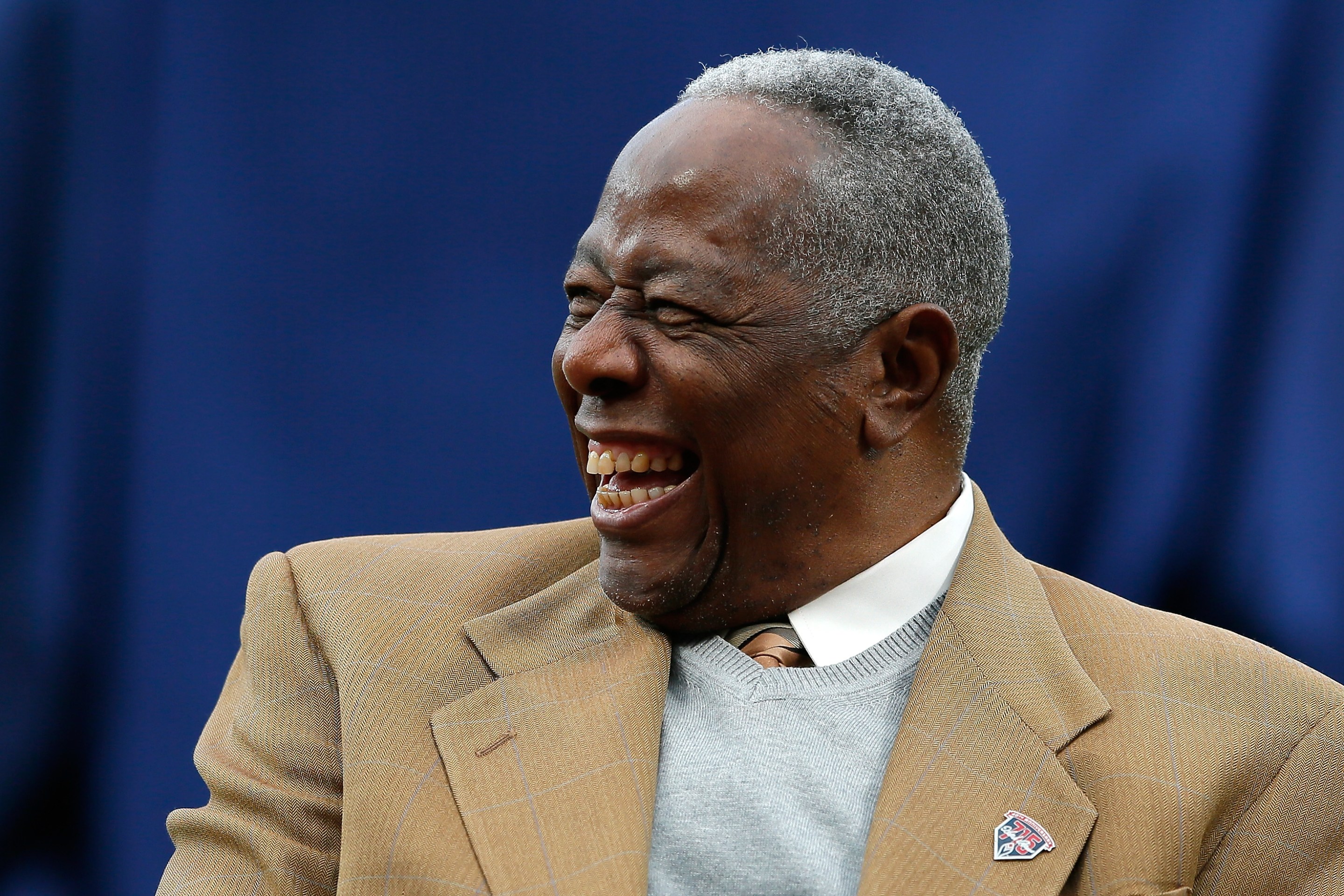 Hank Aaron, seen here laughing at a Mets/Braves game.
