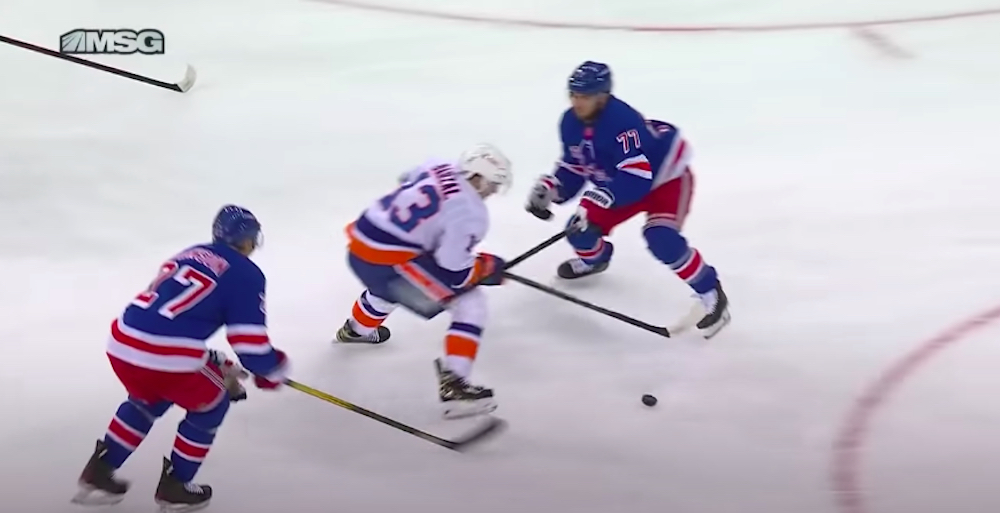 Tony DeAngelo of the New York Rangers is partially responsible for a goal by Mathew Barzal of the New York Islanders