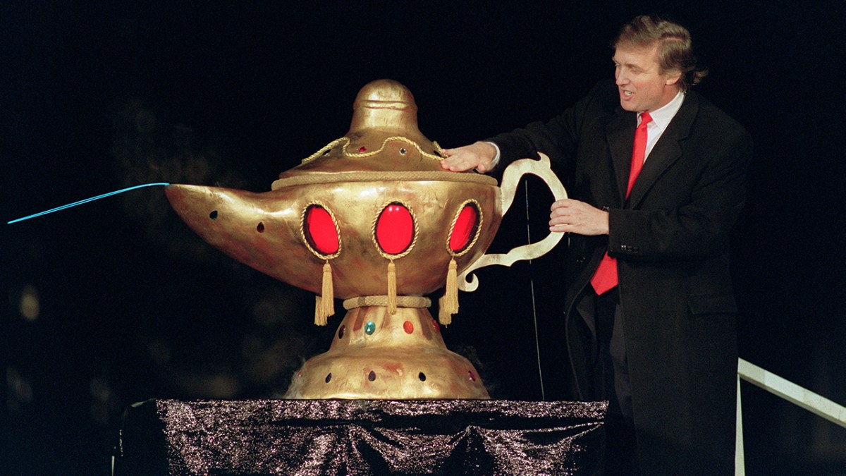 Donald Trump, in 1990, rubbing a magic lamp at the opening of his casino the Trump Taj Mahal