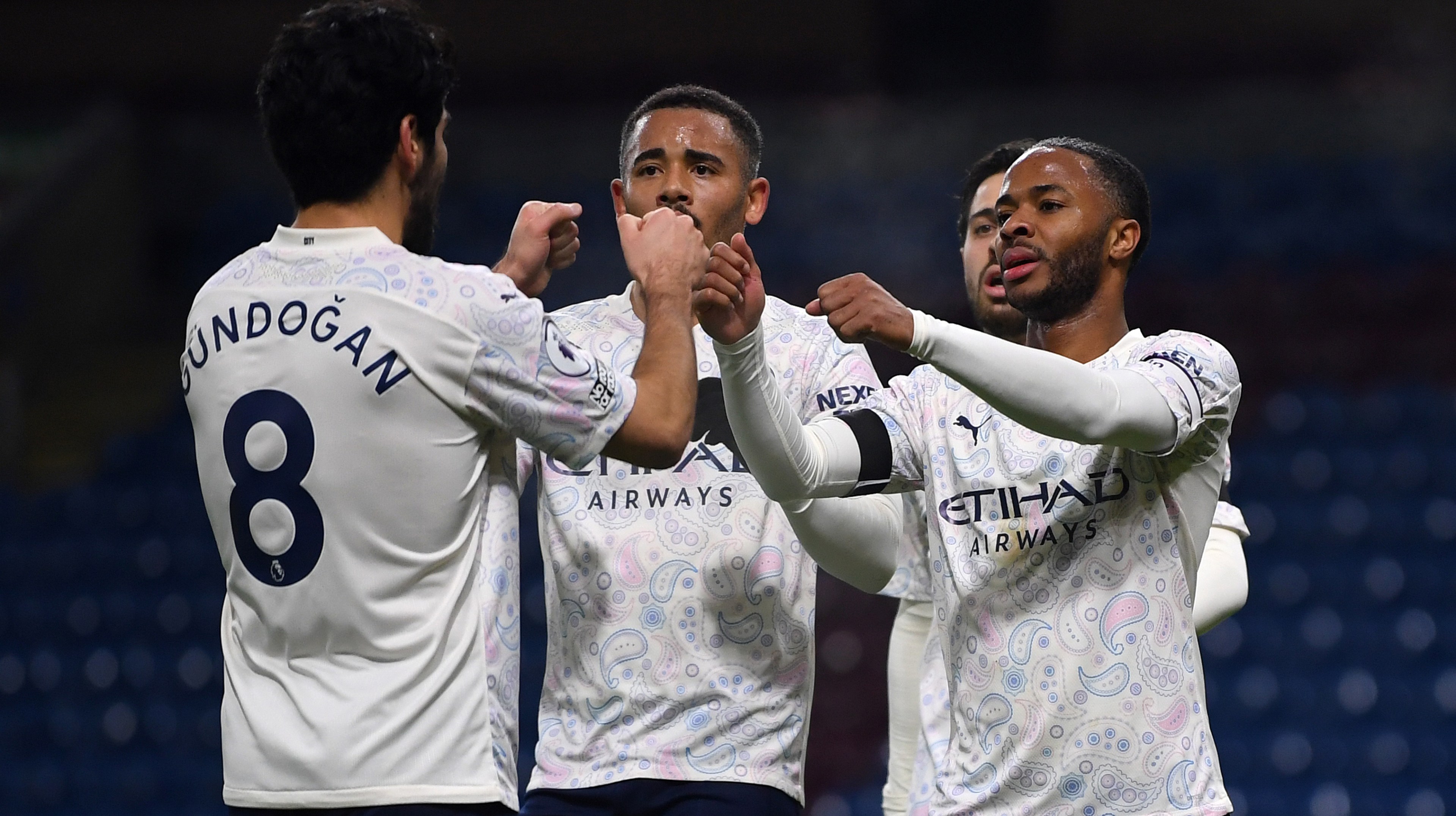 Manchester City's English midfielder Raheem Sterling (R) celebrates scoring his team's second goal with Manchester City's Brazilian striker Gabriel Jesus (C) during the English Premier League football match between Burnley and Manchester City at Turf Moor in Burnley, north west England on February 3, 2021.