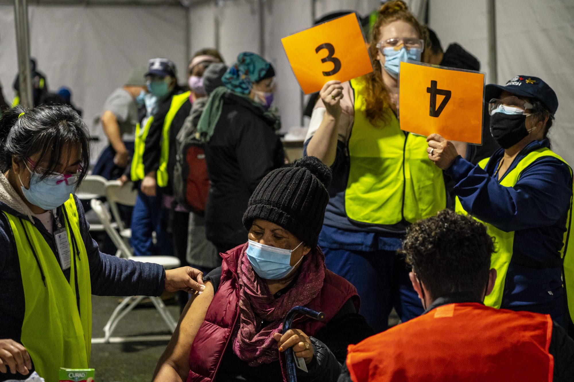 A patient receives a COVID-19 vaccination on February 4, 2021 in Federal Way, Washington. Swedish Medical Center held a mobile vaccination clinic at the Pacific Islander Community Association of Washington to serve racial and ethnic minority groups disproportionately affected by COVID-19.
