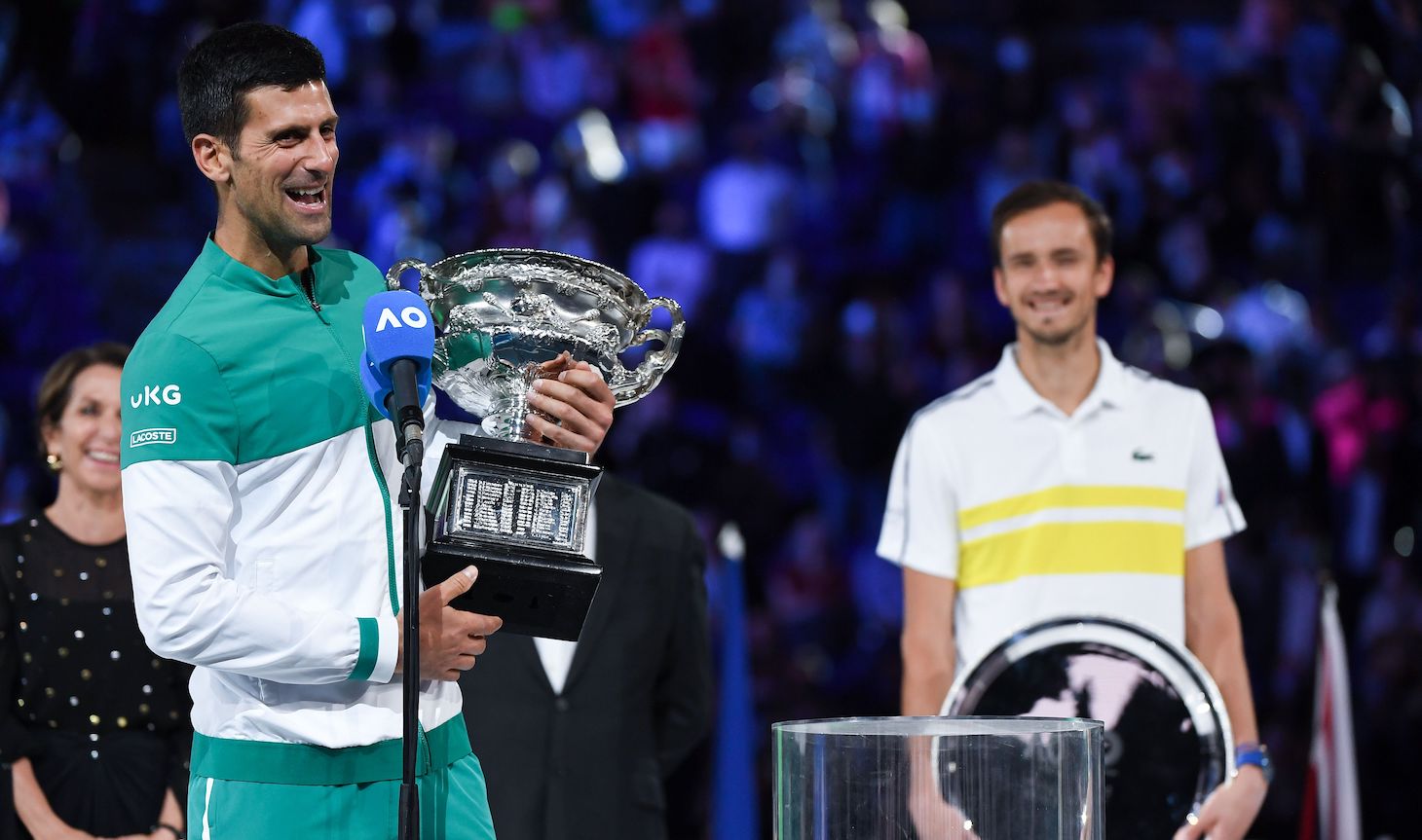 Serbia's Novak Djokovic speaks holding the Norman Brookes Challenge Cup trophy following his victory against Russia's Daniil Medvedev in their men's singles final match on day fourteen of the Australian Open tennis tournament in Melbourne on February 21, 2021. (Photo by William WEST / AFP) / -- IMAGE RESTRICTED TO EDITORIAL USE - STRICTLY NO COMMERCIAL USE -- (Photo by WILLIAM WEST/AFP via Getty Images)