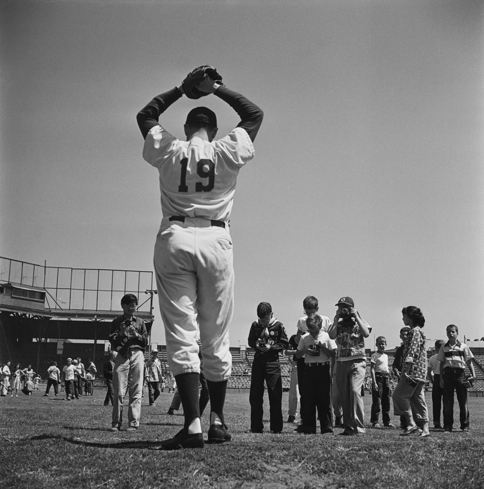 Kids photograph a pitcher for the Pacific Coast League's Oakland Acorns in 1952.