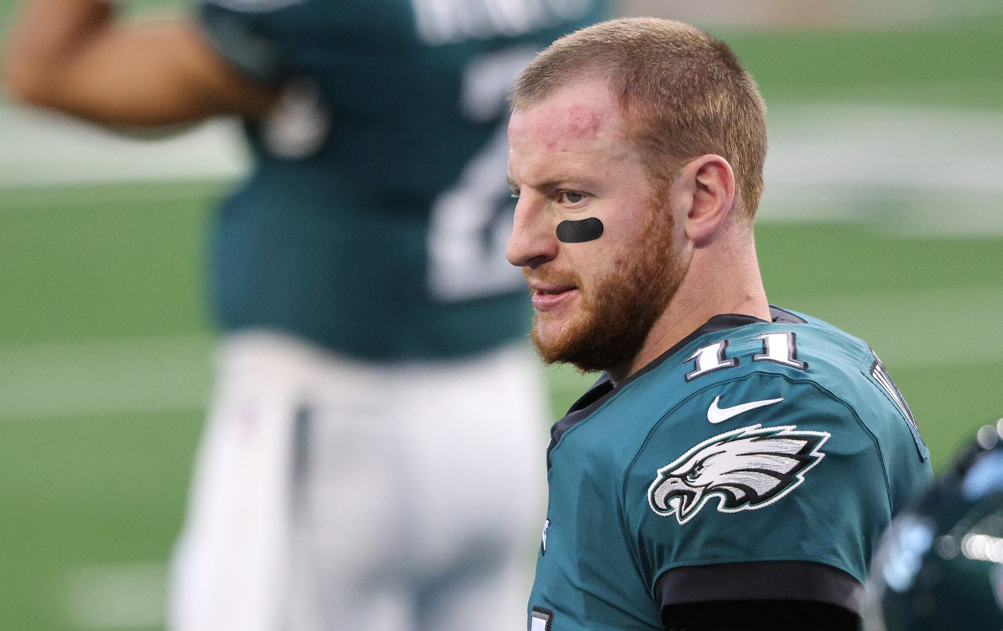 ARLINGTON, TEXAS - DECEMBER 27: Carson Wentz #11 of the Philadelphia Eagles looks on before the game against the Dallas Cowboys at AT&T Stadium on December 27, 2020 in Arlington, Texas. (Photo by Ronald Martinez/Getty Images)