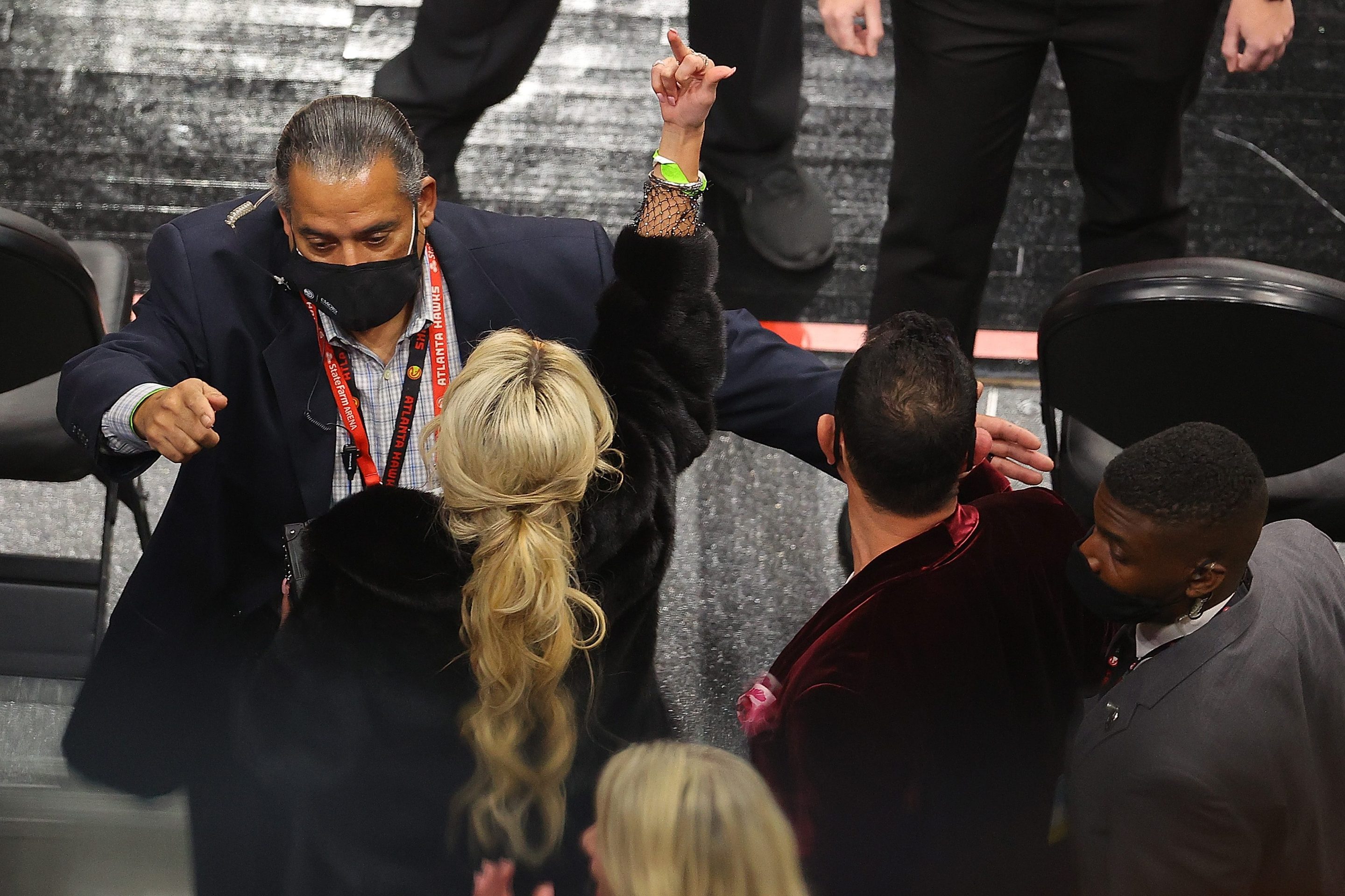 A fan gestures as she and her party are escorted out of the arena during the second half of the game between the Los Angeles Lakers and the Atlanta Hawks at State Farm Arena on February 01, 2021 in Atlanta, Georgia.