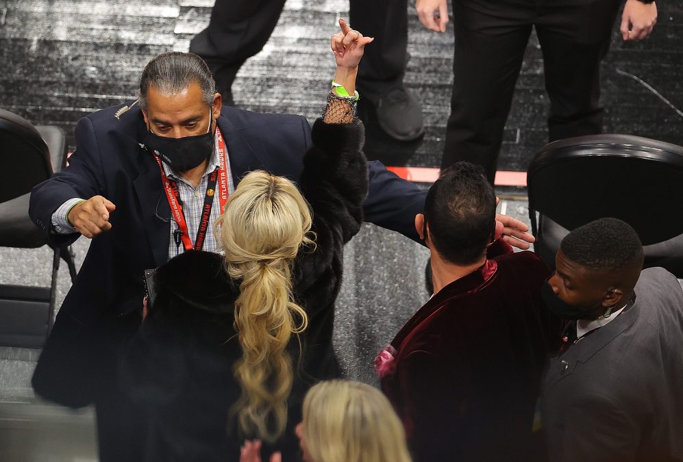 A fan gestures as she and her party are escorted out of the arena during the second half of the game between the Los Angeles Lakers and the Atlanta Hawks at State Farm Arena on February 01, 2021 in Atlanta, Georgia.