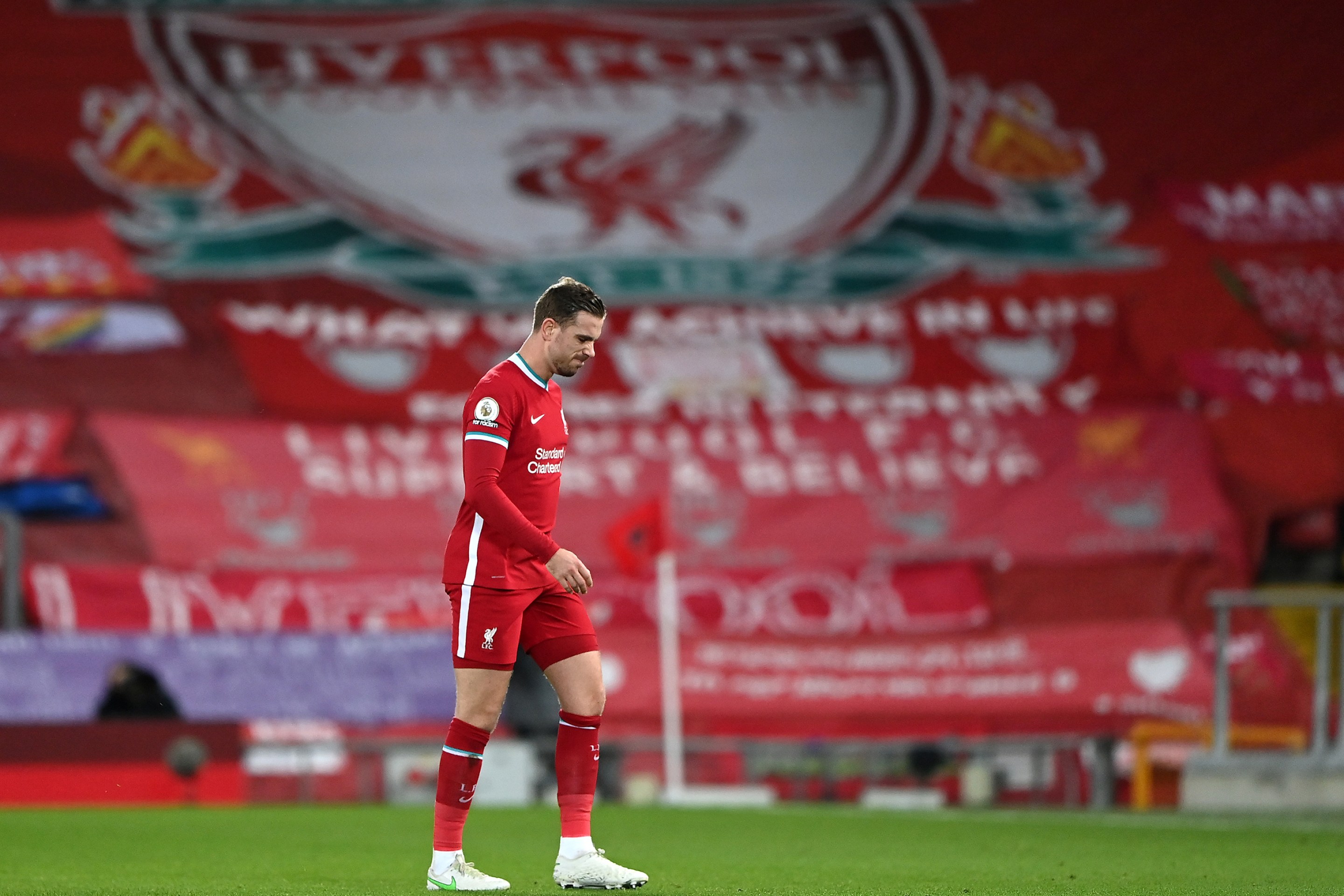 Jordan Henderson of Liverpool leaves the pitch as he is substituted off due to injury during the Premier League match between Liverpool and Everton at Anfield on February 20, 2021 in Liverpool, England