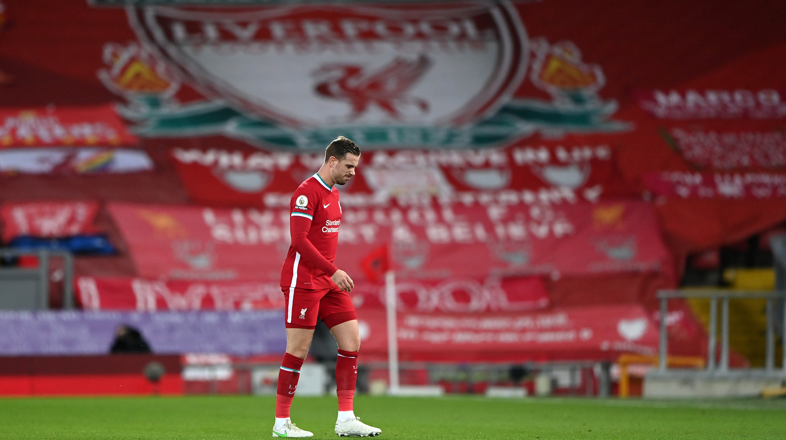 Jordan Henderson of Liverpool leaves the pitch as he is substituted off due to injury during the Premier League match between Liverpool and Everton at Anfield on February 20, 2021 in Liverpool, England