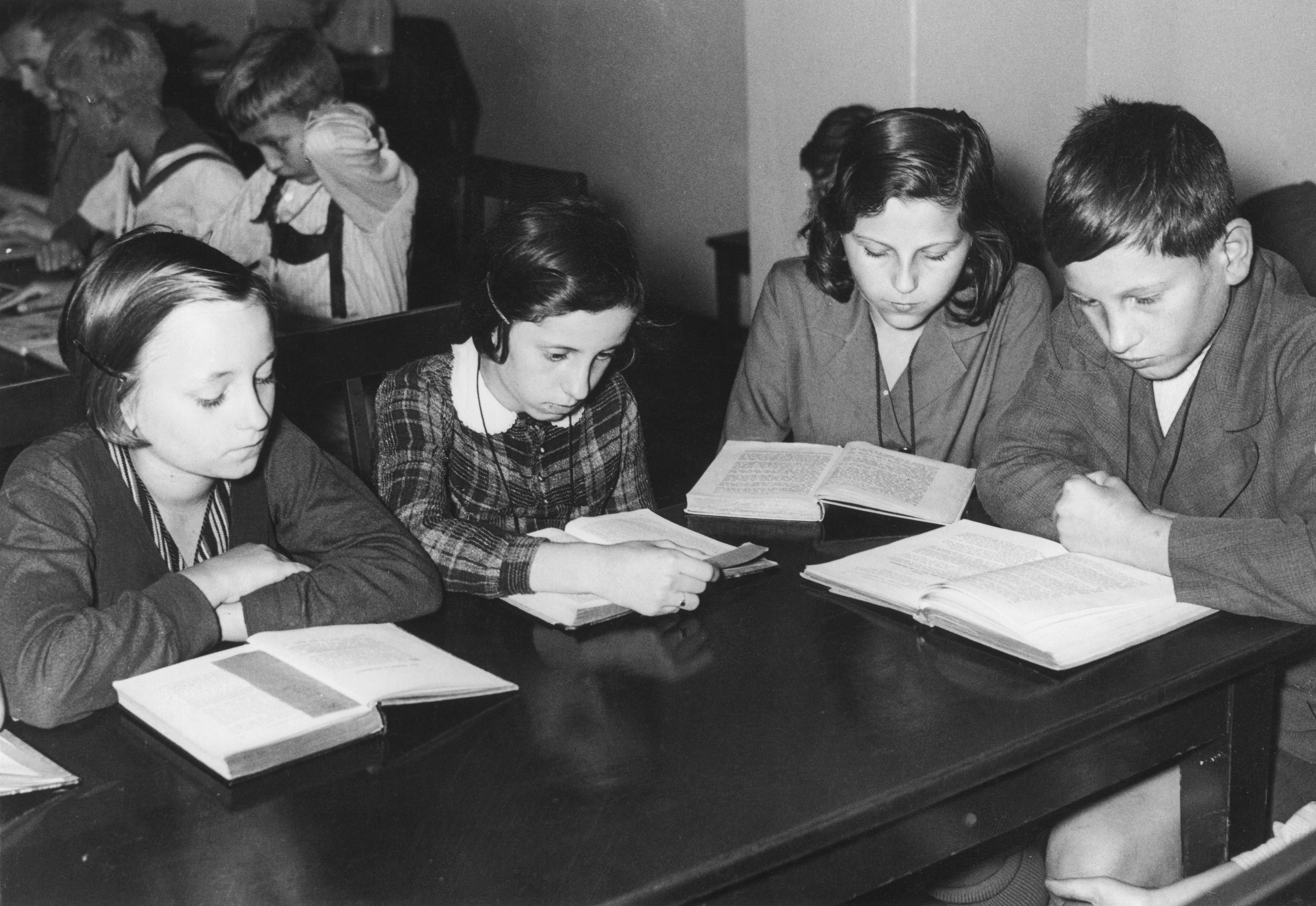 Children reading in the library at their school in Alsace, circa 1950.