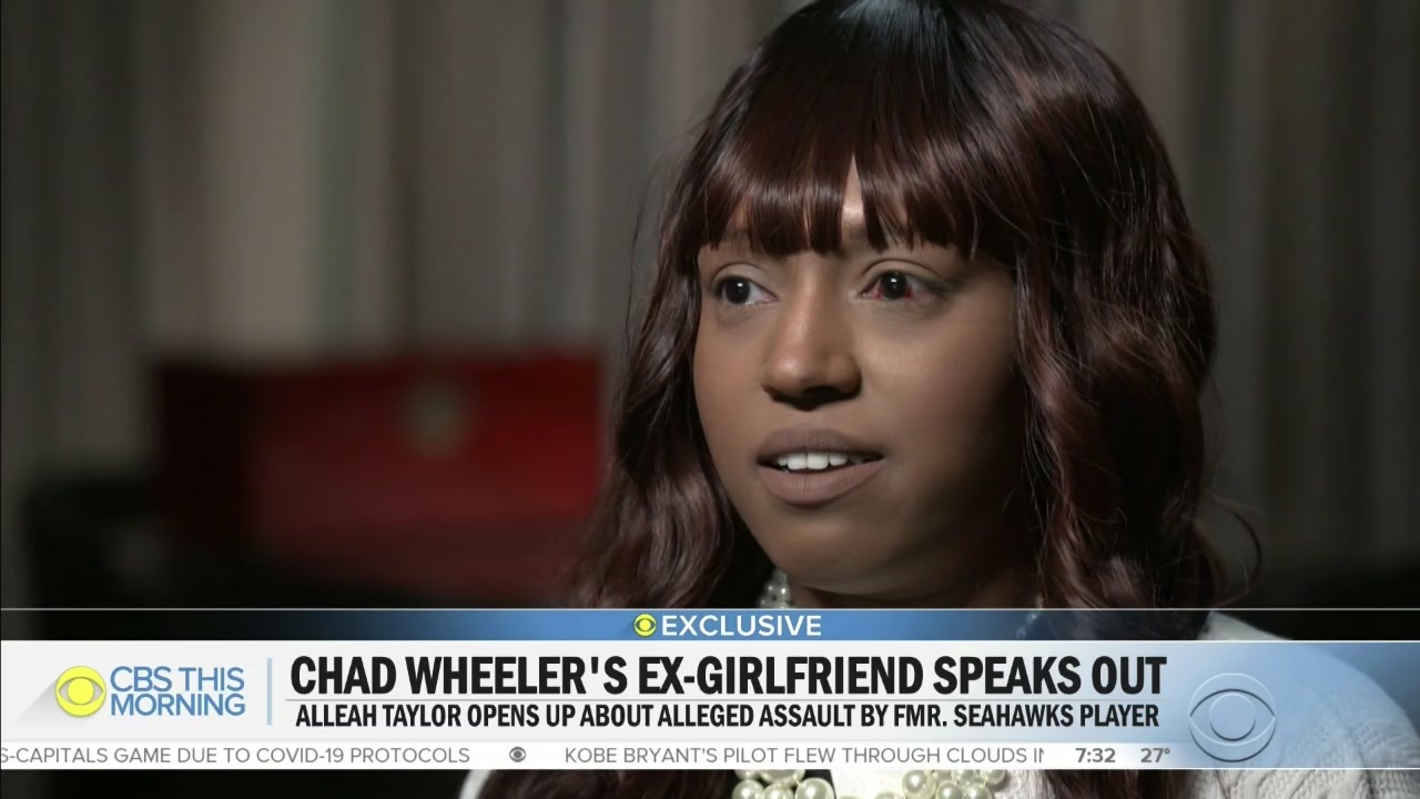 A photo of Alleah Taylor as she speaks to CBS This Morning about being attacked by her ex-boyfriend, former Seattle Seahawks lineman Chad Wheeler. She is wearing a white blouse and has one arm in a sling.
