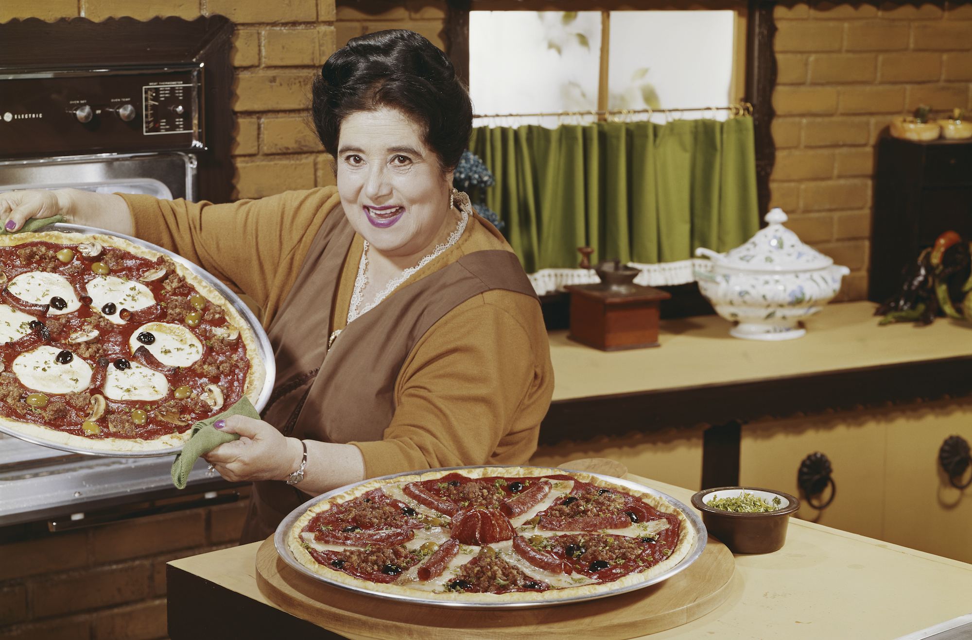 Woman preparing pizza in kitchen, portrait
