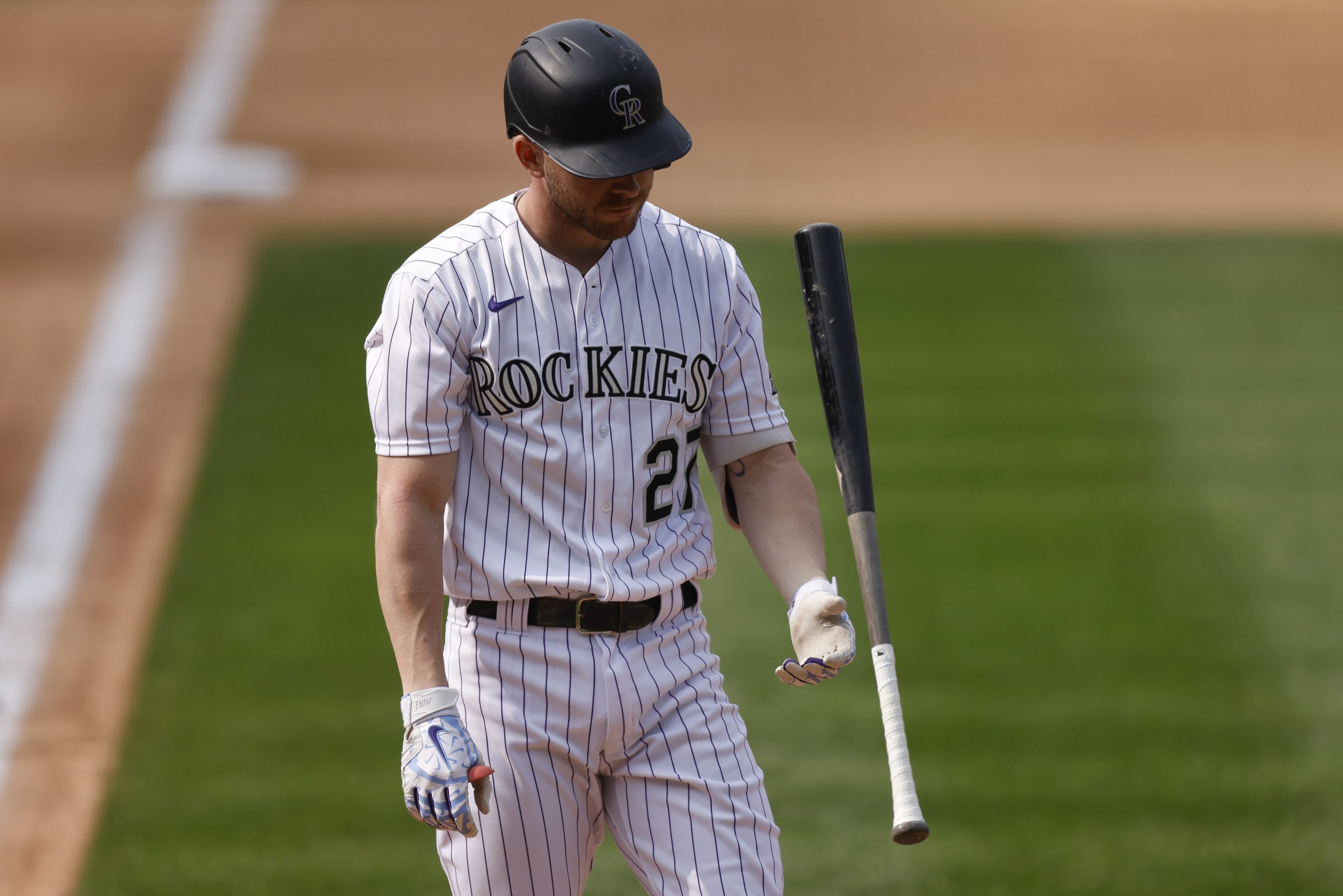 Rockies shortstop Trevor Story discards his bat after striking out.