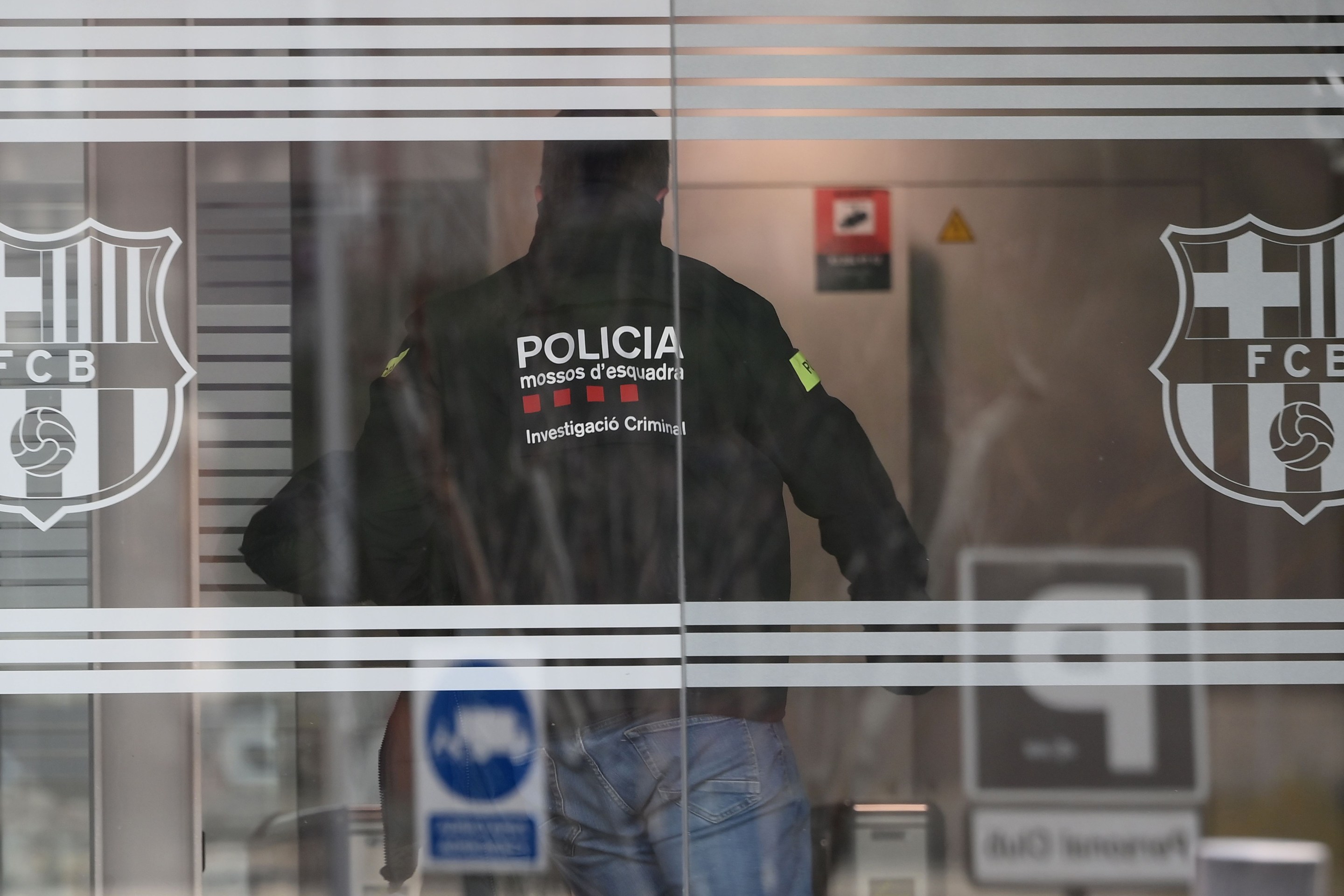 A policeman enters the offices of the Barcelona Football Club on March 01, 2021 in Barcelona during a police operation inside the building.