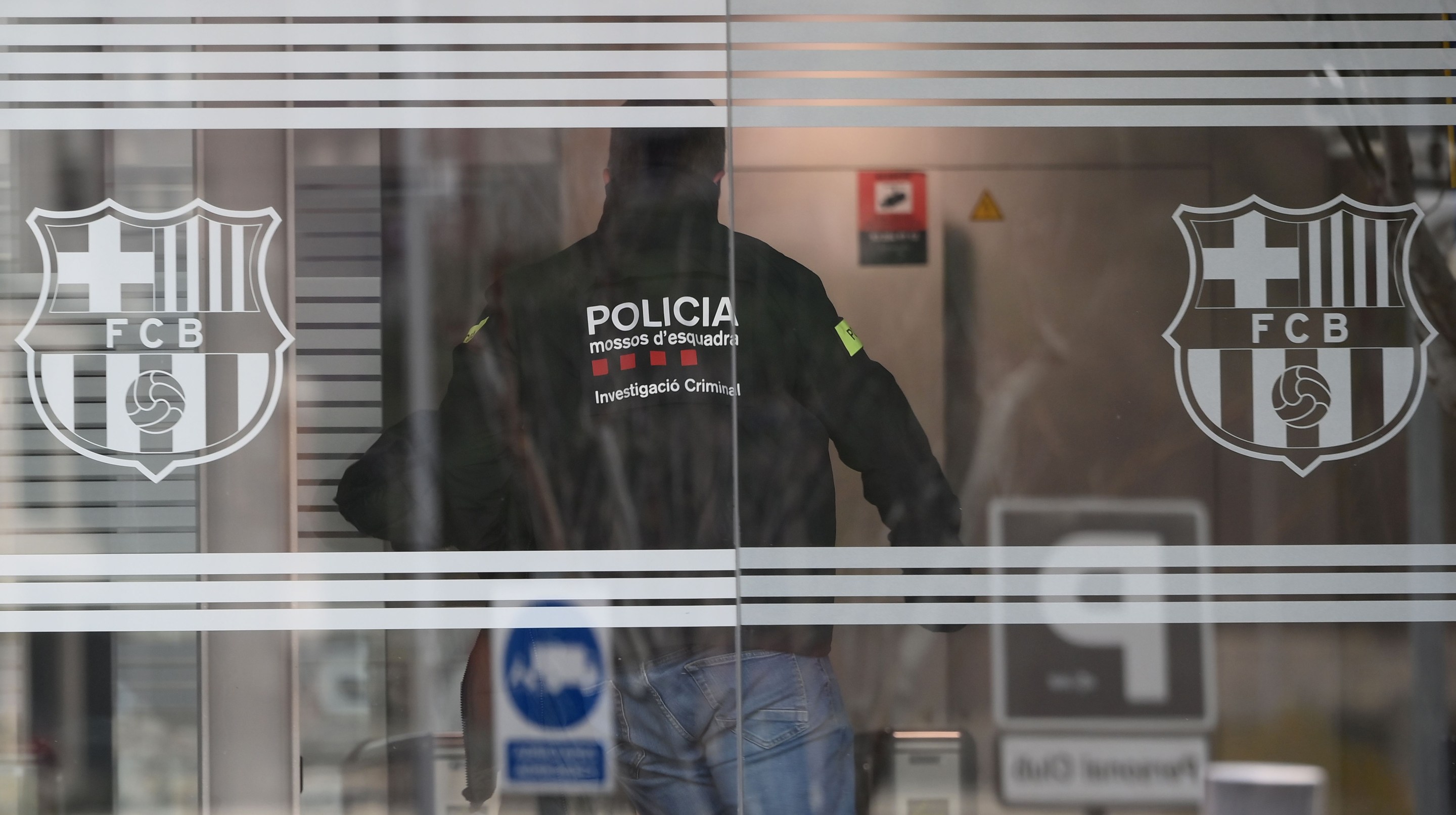 A policeman enters the offices of the Barcelona Football Club on March 01, 2021 in Barcelona during a police operation inside the building.