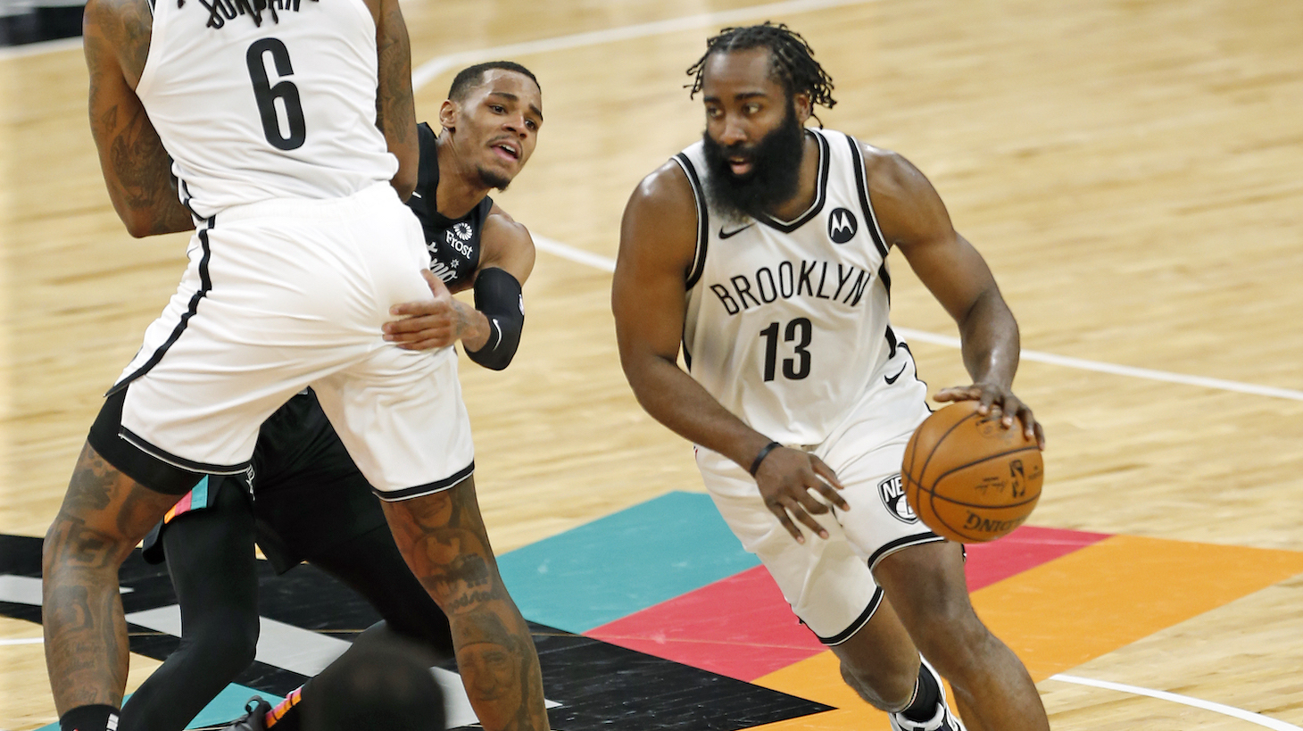 SAN ANTONIO, TX - MARCH 1: James Harden #13 of the Brooklyn Nets drives off a screen by DeAndre Jordan #6 against Dejounte Murray #5 of the San Antonio Spurs in the second half at AT&amp;T Center on March 1, 2021 in San Antonio, Texas. NOTE TO USER: User expressly acknowledges and agrees that , by downloading and or using this photograph, User is consenting to the terms and conditions of the Getty Images License Agreement. (Photo by Ronald Cortes/Getty Images)
