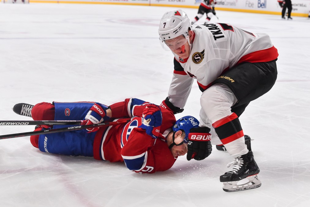 Brady Tkachuk #7 of the Ottawa Senators takes down Artturi Lehkonen #62 of the Montreal Canadiens