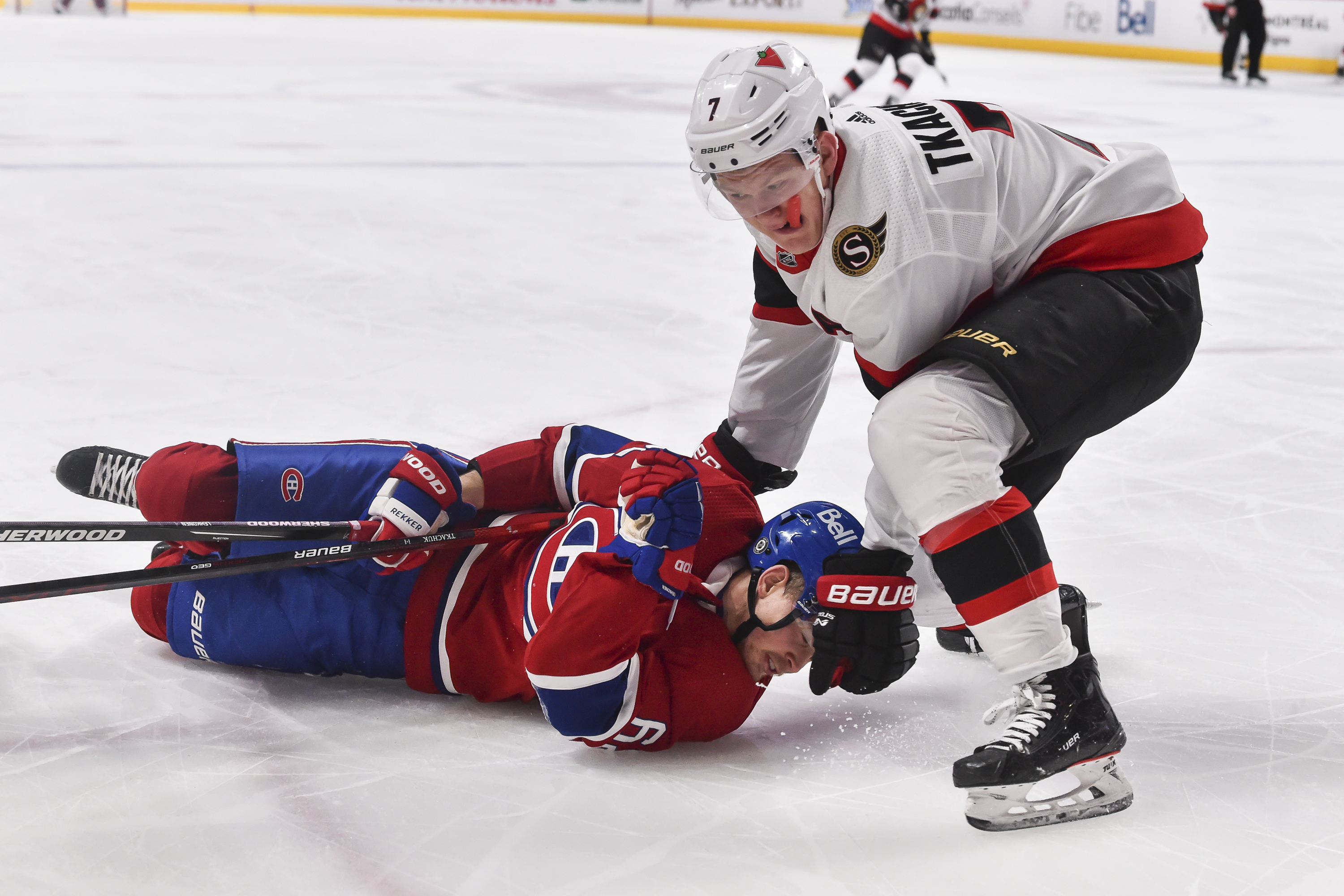 Brady Tkachuk #7 of the Ottawa Senators takes down Artturi Lehkonen #62 of the Montreal Canadiens