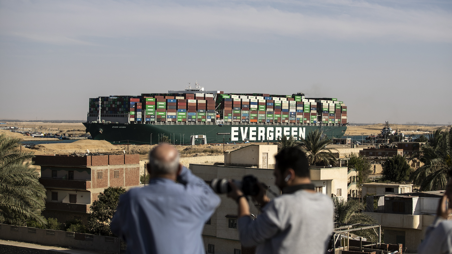 SUEZ, EGYPT - MARCH 29: The container ship 'Ever Given' is refloated, unblocking the Suez Canal on March 29, 2021 in Suez, Egypt. This morning the container ship came partly unstuck from the shoreline, where it ran aground in the canal last Tuesday, and later resumed its course shortly after 3pm local time. The Suez Canal is one of the world's busiest shipping lanes and the blockage had created a backlog of vessels at either end, raising concerns over the impact on global shipping and supply chains. (Photo by Mahmoud Khaled/Getty Images)