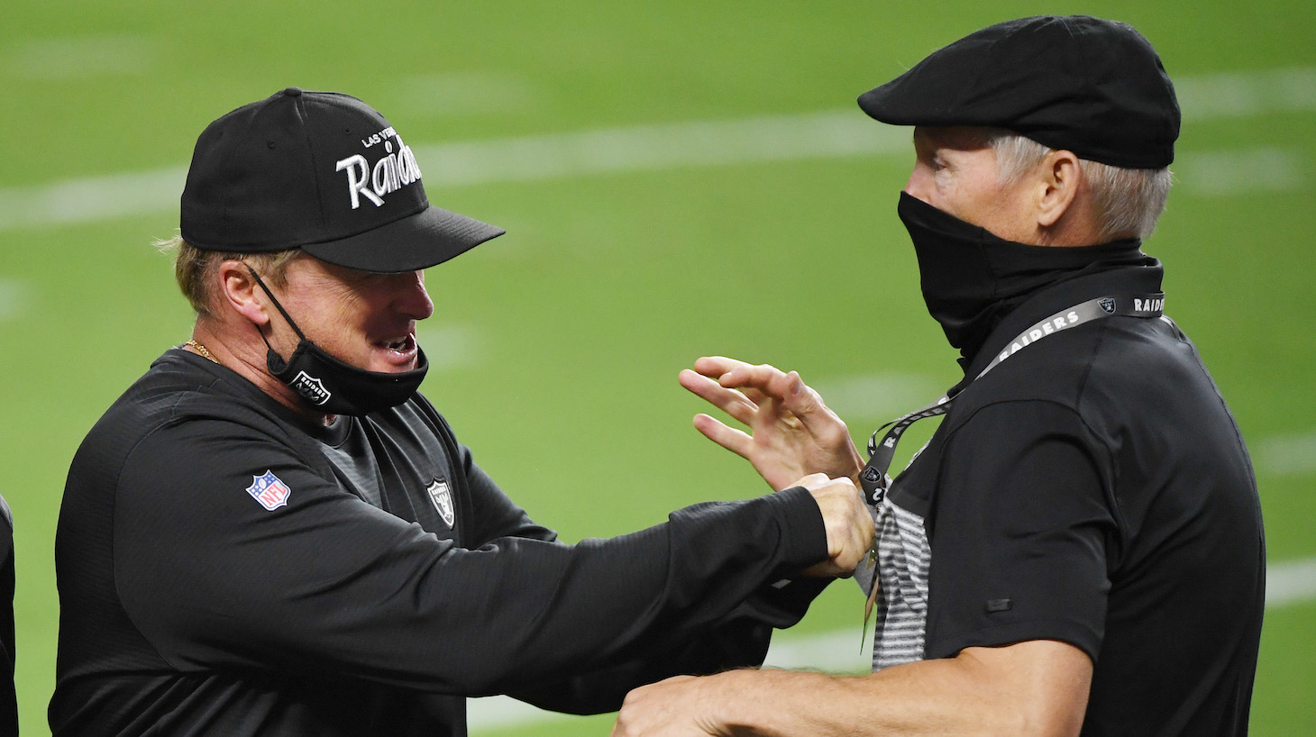 LAS VEGAS, NEVADA - SEPTEMBER 21: Head coach Jon Gruden (L) and general manager Mike Mayock of the Las Vegas Raiders celebrate on the field after the Raiders defeated the New Orleans Saints 34-24 in the NFL game at Allegiant Stadium on September 21, 2020 in Las Vegas, Nevada. (Photo by Ethan Miller/Getty Images)
