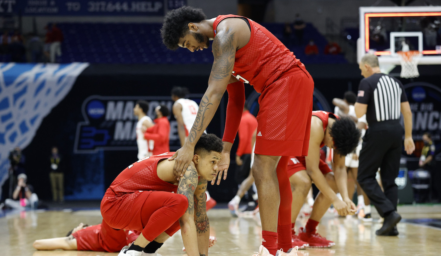 INDIANAPOLIS, INDIANA - MARCH 21: Jacob Young #42 and Myles Johnson #15 of the Rutgers Scarlet Knights react after being defeated by the Houston Cougars 63-60 in the second round game of the 2021 NCAA Men's Basketball Tournament at Lucas Oil Stadium on March 21, 2021 in Indianapolis, Indiana. (Photo by Tim Nwachukwu/Getty Images)