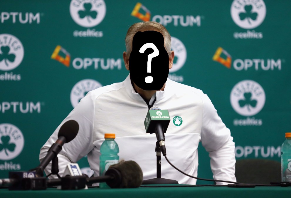 A mysterious, unknown NBA general manager, sitting in front of a Celtics backdrop and speaking into a Celtics-branded microphone.