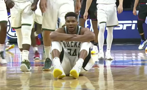 Giannis sits on the court during a timeout in Milwaukee's win over the 76ers.