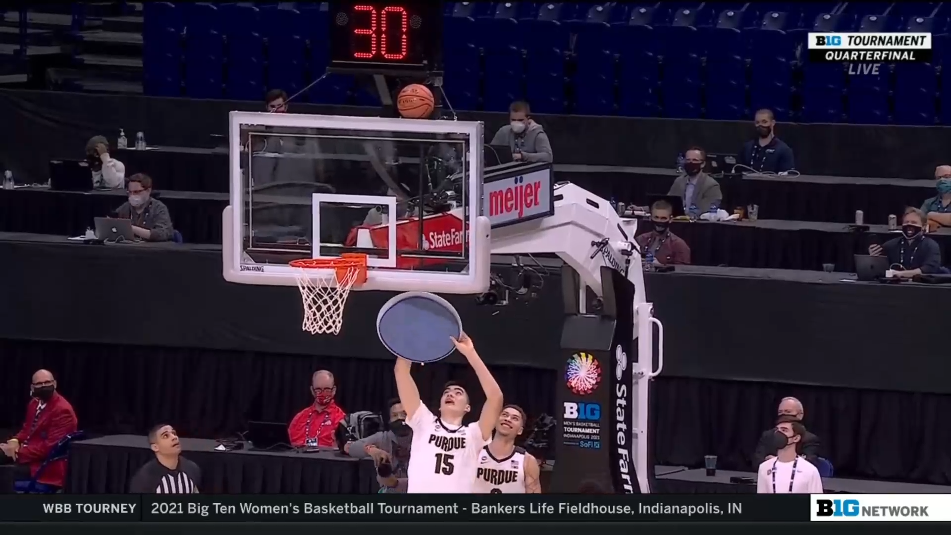 zach edey knocks the ball off the top of the basket